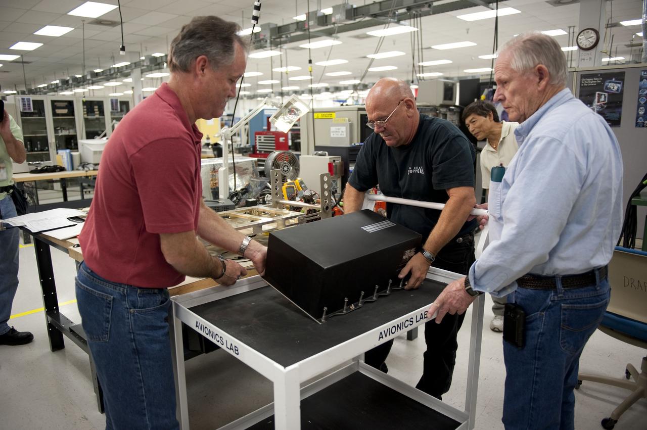 CAPE CANAVERAL, Fla. -- At the NASA Shuttle Logistics Depot in Cape Canaveral, Florida, technicians carefully remove the Load Control Assembly-2 (LCA-2) from a cart for testing.          Located in space shuttle Endeavour's aft avionics bay 5, the LCA-2, which distributes power to nine shuttle systems, is believed to have caused fuel line heaters for Endeavour's auxiliary power unit-1 (APU-1) to fail April 29 during the first launch attempt for the STS-134 mission. The LCA-2 will be replaced and systems will be retested before the launch is rescheduled. STS-134 will deliver the Express Logistics Carrier-3, Alpha Magnetic Spectrometer-2 (AMS), a high-pressure gas tank and additional spare parts for the Dextre robotic helper to the International Space Station. The mission also will be the final spaceflight for Endeavour. For more information, visit www.nasa.gov/mission_pages/shuttle/shuttlemissions/sts134/index.html. Photo credit: NASA/Kim Shiflett