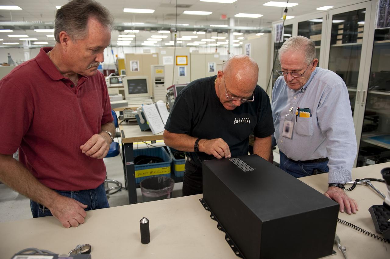 CAPE CANAVERAL, Fla. -- At the NASA Shuttle Logistics Depot in Cape Canaveral, Florida, technicians remove the cover on the Load Control Assembly-2 (LCA-2) to begin the testing process. Located in space shuttle Endeavour's aft avionics bay 5, the LCA-2, which distributes power to nine shuttle systems, is believed to have caused fuel line heaters for Endeavour's auxiliary power unit-1 (APU-1) to fail April 29 during the first launch attempt for the STS-134 mission. The LCA-2 will be replaced and systems will be retested before the launch is rescheduled. STS-134 will deliver the Express Logistics Carrier-3, Alpha Magnetic Spectrometer-2 (AMS), a high-pressure gas tank and additional spare parts for the Dextre robotic helper to the International Space Station. The mission also will be the final spaceflight for Endeavour. For more information, visit www.nasa.gov/mission_pages/shuttle/shuttlemissions/sts134/index.html. Photo credit: NASA/Kim Shiflett