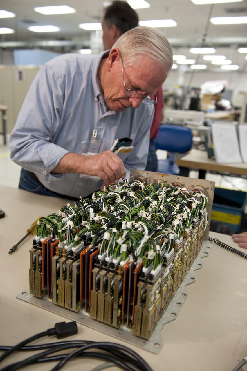 CAPE CANAVERAL, Fla. -- At the NASA Shuttle Logistics Depot in Cape Canaveral, Florida, technicians begin the testing process on the Load Control Assembly-2 (LCA-2) after the cover has been removed.        Located in space shuttle Endeavour's aft avionics bay 5, the LCA-2, which distributes power to nine shuttle systems, is believed to have caused fuel line heaters for Endeavour's auxiliary power unit-1 (APU-1) to fail April 29 during the first launch attempt for the STS-134 mission. The LCA-2 will be replaced and systems will be retested before the launch is rescheduled. STS-134 will deliver the Express Logistics Carrier-3, Alpha Magnetic Spectrometer-2 (AMS), a high-pressure gas tank and additional spare parts for the Dextre robotic helper to the International Space Station. The mission also will be the final spaceflight for Endeavour. For more information, visit www.nasa.gov/mission_pages/shuttle/shuttlemissions/sts134/index.html. Photo credit: NASA/Kim Shiflett