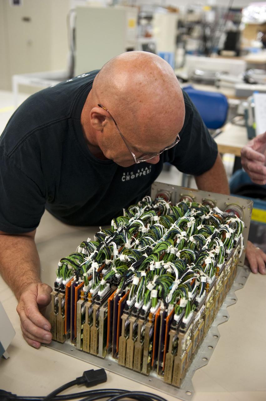 CAPE CANAVERAL, Fla. -- At the NASA Shuttle Logistics Depot in Cape Canaveral, Florida, technicians begin the testing process on the Load Control Assembly-2 (LCA-2) after the cover has been removed.        Located in space shuttle Endeavour's aft avionics bay 5, the LCA-2, which distributes power to nine shuttle systems, is believed to have caused fuel line heaters for Endeavour's auxiliary power unit-1 (APU-1) to fail April 29 during the first launch attempt for the STS-134 mission. The LCA-2 will be replaced and systems will be retested before the launch is rescheduled. STS-134 will deliver the Express Logistics Carrier-3, Alpha Magnetic Spectrometer-2 (AMS), a high-pressure gas tank and additional spare parts for the Dextre robotic helper to the International Space Station. The mission also will be the final spaceflight for Endeavour. For more information, visit www.nasa.gov/mission_pages/shuttle/shuttlemissions/sts134/index.html. Photo credit: NASA/Kim Shiflett