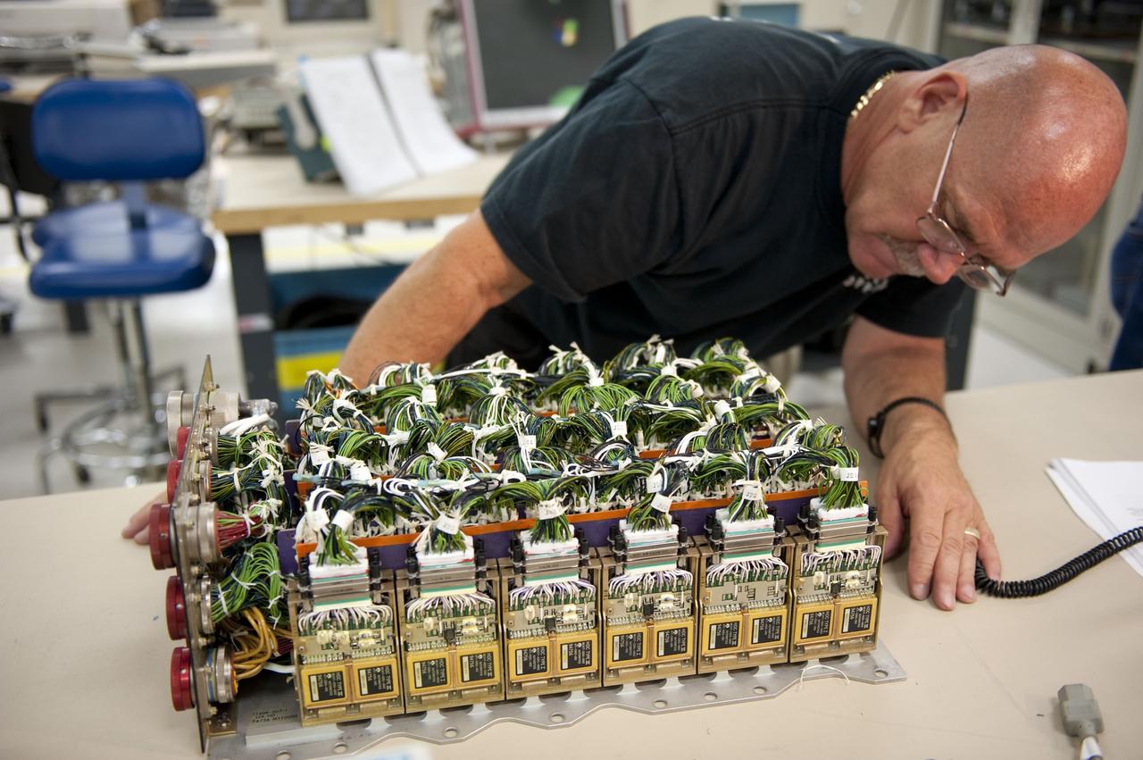 CAPE CANAVERAL, Fla. -- At the NASA Shuttle Logistics Depot in Cape Canaveral, Florida, technicians begin the testing process on the Load Control Assembly-2 (LCA-2) after the cover has been removed.        Located in space shuttle Endeavour's aft avionics bay 5, the LCA-2, which distributes power to nine shuttle systems, is believed to have caused fuel line heaters for Endeavour's auxiliary power unit-1 (APU-1) to fail April 29 during the first launch attempt for the STS-134 mission. The LCA-2 will be replaced and systems will be retested before the launch is rescheduled. STS-134 will deliver the Express Logistics Carrier-3, Alpha Magnetic Spectrometer-2 (AMS), a high-pressure gas tank and additional spare parts for the Dextre robotic helper to the International Space Station. The mission also will be the final spaceflight for Endeavour. For more information, visit www.nasa.gov/mission_pages/shuttle/shuttlemissions/sts134/index.html. Photo credit: NASA/Kim Shiflett
