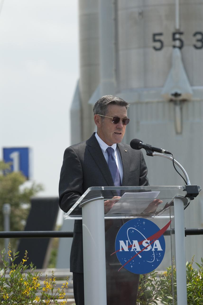 CAPE CANAVERAL, Fla. -- In the Rocket Garden at NASA's Kennedy Space Center Visitor Complex in Florida, Center Director Bob Cabana addresses the audience to announce the United States Postal Service unveiling of two new stamps to commemorate the 50th anniversary of human spaceflight.          One stamp commemorates NASA's Project Mercury and Alan Shepard's historic launch on May 5, 1961, aboard the spacecraft Freedom 7. The second stamp honors NASA's MESSENGER, which reached Mercury in March to become the first spacecraft to orbit the planet. The two missions frame a remarkable 50-year period in which America advanced space exploration through more than 1,500 crewed and uncrewed flights. Photo credit: NASA/Kim Shiflett