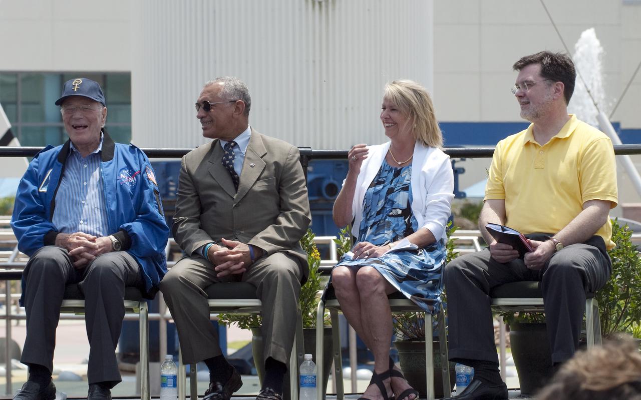 CAPE CANAVERAL, Fla. -- In the Rocket Garden at NASA's Kennedy Space Center Visitor Complex in Florida, Mercury Astronaut Scott Carpenter, NASA Administrator Charlie Bolden, Julie Jenkins, daughter of Mercury Astronaut Alan Shepard, and NASA's Deputy Director for Planetary Science, Jim Adams, enjoy a light moment during an event unveiling two new stamps to commemorate the 50th anniversary of human spaceflight from the United States Postal Service.            One stamp commemorates NASA's Project Mercury and Alan Shepard's historic launch on May 5, 1961, aboard the spacecraft Freedom 7. The second stamp honors NASA's MESSENGER, which reached Mercury in March to become the first spacecraft to orbit the planet. The two missions frame a remarkable 50-year period in which America advanced space exploration through more than 1,500 crewed and uncrewed flights. Photo credit: NASA/Kim Shiflett