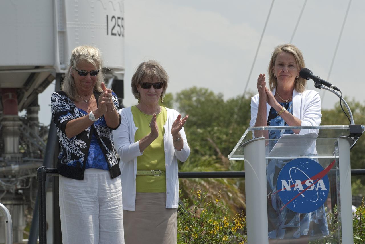 CAPE CANAVERAL, Fla. -- In the Rocket Garden at NASA's Kennedy Space Center Visitor Complex in Florida, Laura Churchley (left), Alice Wackerman and Julie Jenkins, daughters of Mercury Astronaut Alan Shepard, applaud during an event unveiling two new stamps to commemorate the 50th anniversary of human spaceflight from the United States Postal Service.  One stamp commemorates NASA's Project Mercury and Alan Shepard's historic launch on May 5, 1961, aboard the spacecraft Freedom 7. The second stamp honors NASA's MESSENGER, which reached Mercury in March to become the first spacecraft to orbit the planet. The two missions frame a remarkable 50-year period in which America advanced space exploration through more than 1,500 crewed and uncrewed flights. Photo credit: NASA/Kim Shiflett