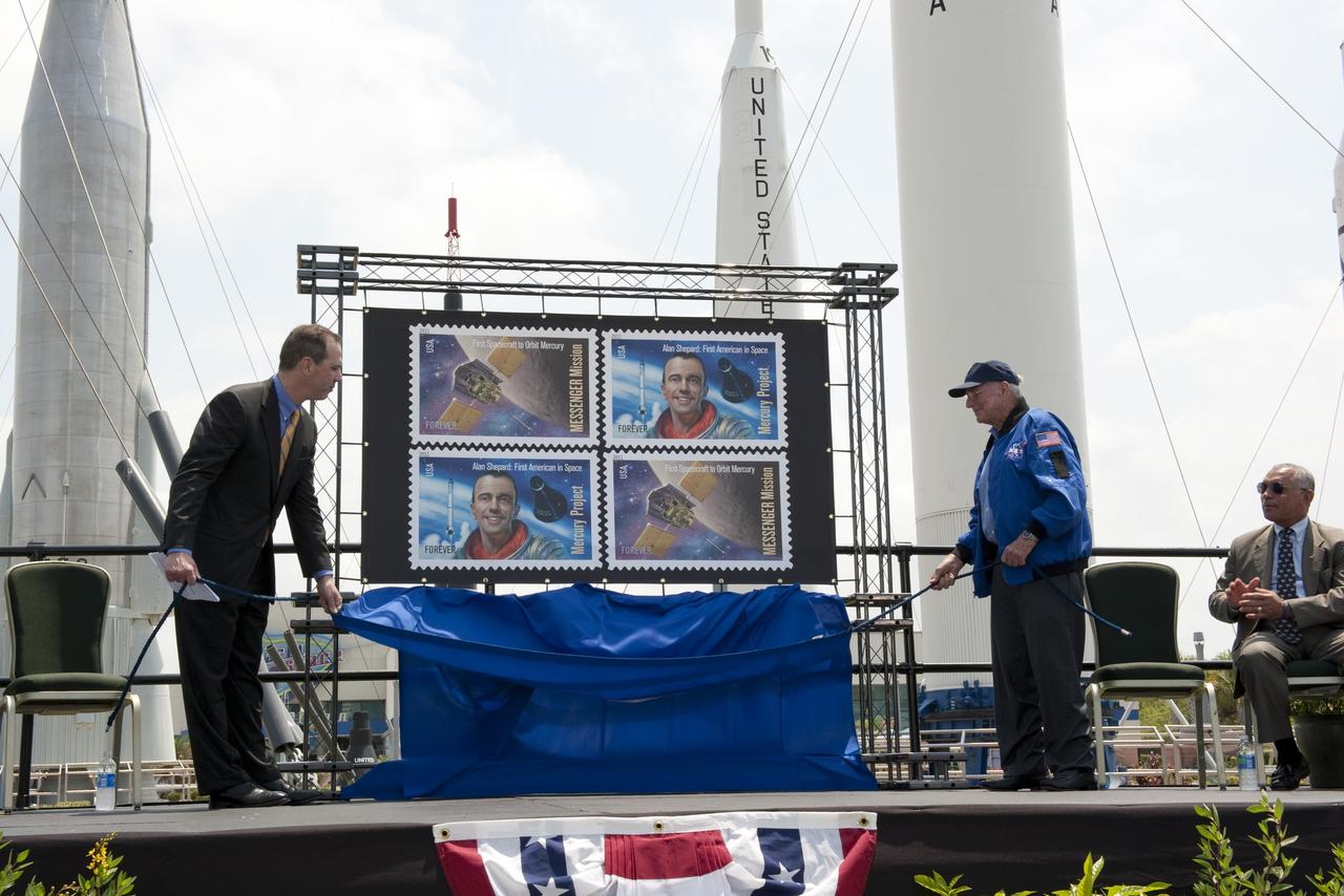 CAPE CANAVERAL, Fla. -- In the Rocket Garden at NASA's Kennedy Space Center Visitor Complex in Florida, United States Postal Service official Steve Massey and Mercury Astronaut Scott Carpenter have the honor of unveiling the two new stamps that commemorate the 50th anniversary of human spaceflight. Applauding the unveiling is NASA Administrator, Charlie Bolden.            One stamp commemorates NASA's Project Mercury and Alan Shepard's historic launch on May 5, 1961, aboard the spacecraft Freedom 7. The second stamp honors NASA's MESSENGER, which reached Mercury in March to become the first spacecraft to orbit the planet. The two missions frame a remarkable 50-year period in which America advanced space exploration through more than 1,500 crewed and uncrewed flights. Photo credit: NASA/Kim Shiflett