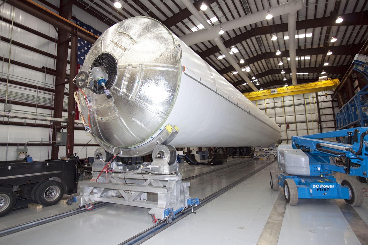 CAPE CANAVERAL, Fla. -- The forward end of the first stage of a Falcon 9 rocket as the stage sits on processing stands inside the Space Exploration Technologies (SpaecX) hangar at Launch Complex 40 at Cape Canaveral Air Force Station in Florida. Technicians are preparing the rocket for the second launch in the Commercial Orbital Transportation Services, or COTS, program to demonstrate private companies' ability to launch uncrewed spacecraft into orbit. A follow-on contract, Commercial Resupply Services, calls for SpaceX to launch 12 resupply missions to the International Space Station between 2011 and 2015. Photo credit: NASA/Jack Pfaller
