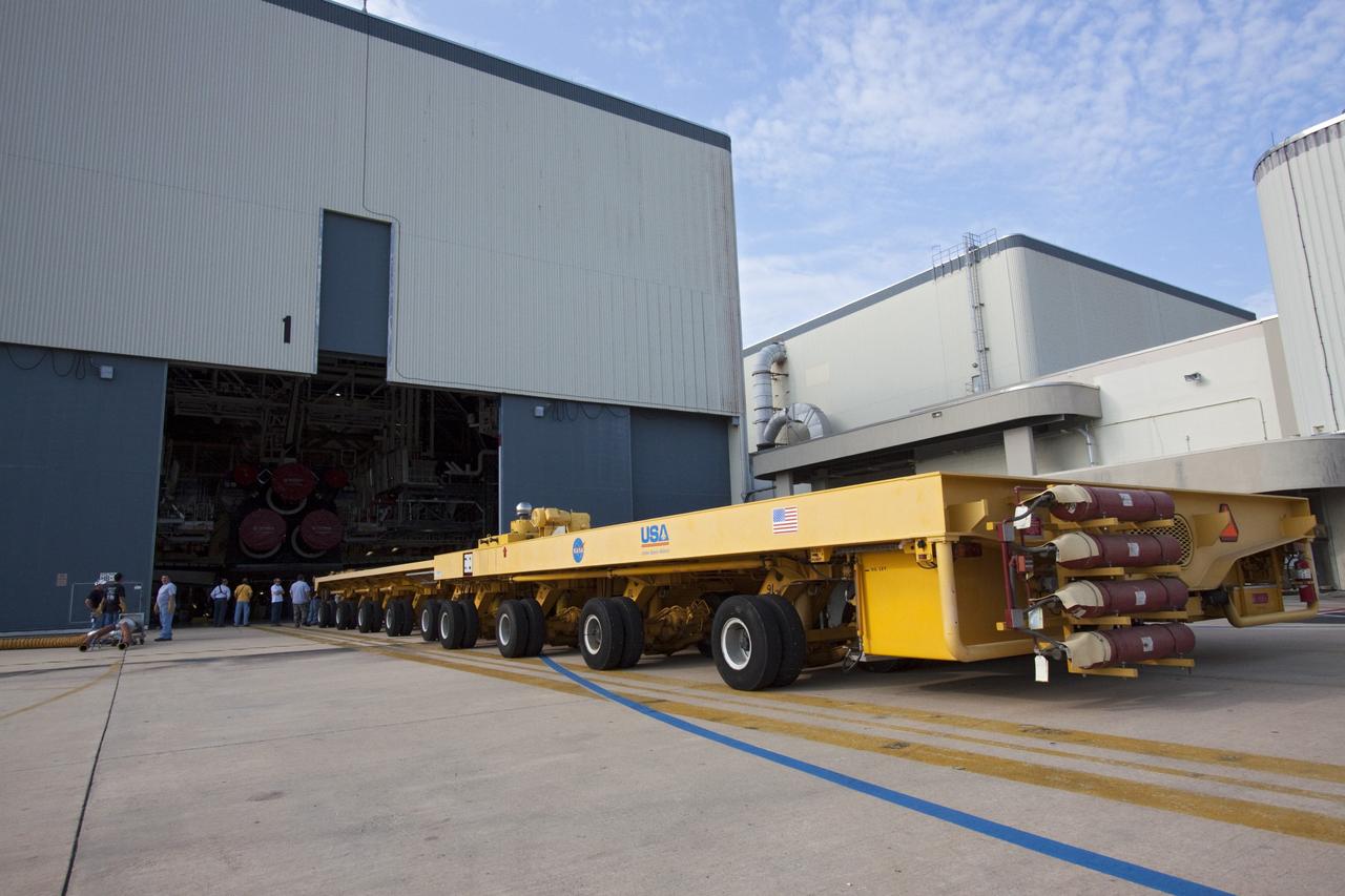 CAPE CANAVERAL, Fla. - Workers move the Orbiter Transporter System (OTS) into Orbiter Processing Facility-1 at NASA's Kennedy Space Center in Florida. The OTS will be moved under shuttle Atlantis for its rollover to the nearby Vehicle Assembly Building (VAB).            Once inside the VAB, Atlantis will be joined to its solid rocket boosters and external fuel tank on the mobile launcher platform. Later this month, Atlantis is scheduled to "rollout" to Launch Pad 39A on the STS-135 mission, which will deliver the Raffaello multi-purpose logistics module packed with supplies and spare parts to the International Space Station. STS-135, targeted to launch June 28, will be the 33rd flight of Atlantis, the 37th shuttle mission to the station, and the 135th and final mission of NASA's Space Shuttle Program. For more information, visit www.nasa.gov/mission_pages/shuttle/shuttlemissions/sts135/index.html. NASA/Jack Pfaller