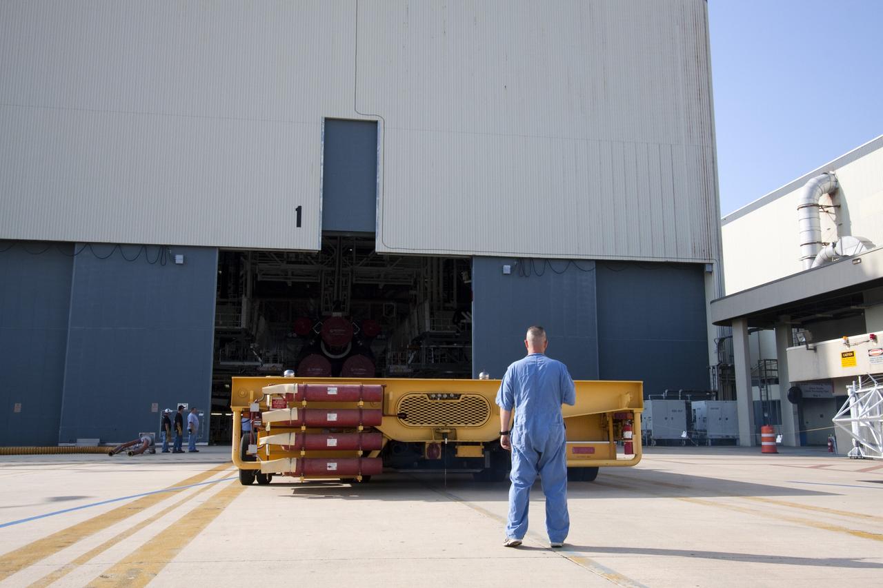 CAPE CANAVERAL, Fla. - In Orbiter Processing Facility-1 at NASA's Kennedy Space Center in Florida, workers guide the Orbiter Transporter System (OTS) under shuttle Atlantis for its move, or rollover, to the nearby Vehicle Assembly Building (VAB).          Once inside the VAB, Atlantis will be joined to its solid rocket boosters and external fuel tank on the mobile launcher platform. Later this month, Atlantis is scheduled to "rollout" to Launch Pad 39A on the STS-135 mission, which will deliver the Raffaello multi-purpose logistics module packed with supplies and spare parts to the International Space Station. STS-135, targeted to launch June 28, will be the 33rd flight of Atlantis, the 37th shuttle mission to the station, and the 135th and final mission of NASA's Space Shuttle Program. For more information, visit www.nasa.gov/mission_pages/shuttle/shuttlemissions/sts135/index.html. NASA/Jack Pfaller