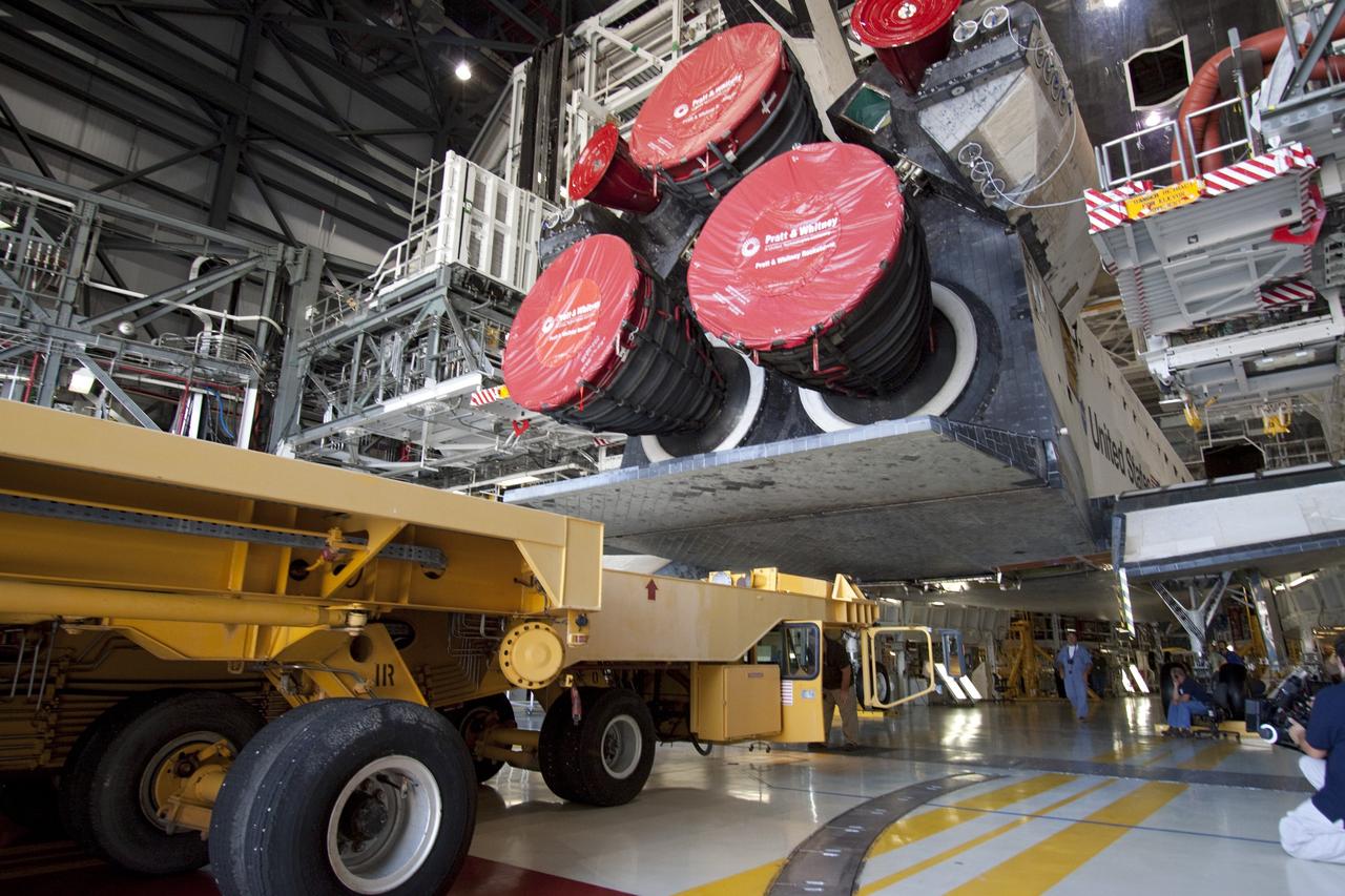 CAPE CANAVERAL, Fla. -- In Orbiter Processing Facility-1 at NASA's Kennedy Space Center in Florida, workers guide the Orbiter Transporter System (OTS) under shuttle Atlantis for its move, or rollover to the nearby Vehicle Assembly Building (VAB).        Once inside the VAB, Atlantis will be joined to its solid rocket boosters and external fuel tank on the mobile launcher platform. Later this month, Atlantis is scheduled to "rollout" to Launch Pad 39A on the STS-135 mission, which will deliver the Raffaello multi-purpose logistics module packed with supplies and spare parts to the International Space Station. STS-135, targeted to launch June 28, will be the 33rd flight of Atlantis, the 37th shuttle mission to the station, and the 135th and final mission of NASA's Space Shuttle Program. For more information, visit www.nasa.gov/mission_pages/shuttle/shuttlemissions/sts135/index.html. NASA/Jack Pfaller