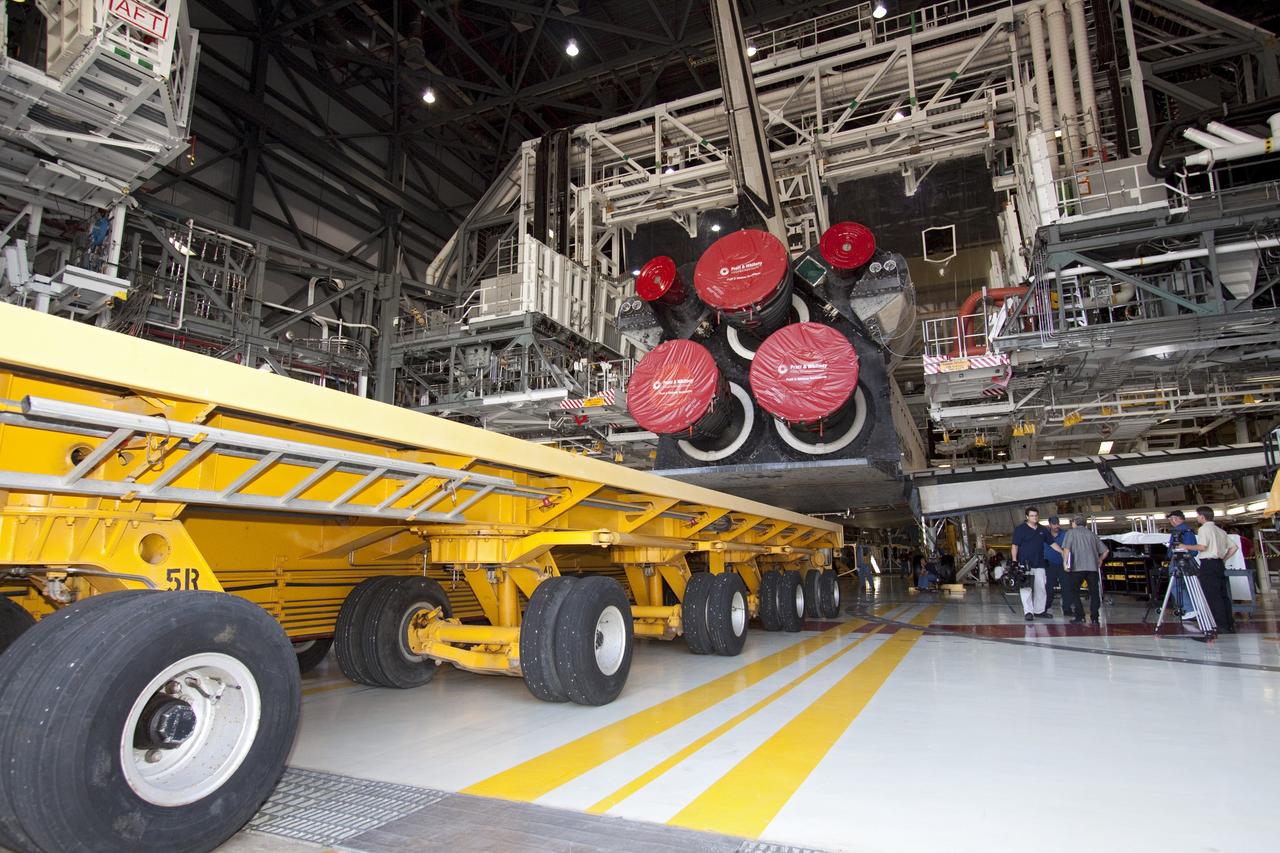 CAPE CANAVERAL, Fla. -- In Orbiter Processing Facility-1 at NASA's Kennedy Space Center in Florida, workers guide the Orbiter Transporter System (OTS) under shuttle Atlantis for its move, or rollover to the nearby Vehicle Assembly Building (VAB).        Once inside the VAB, Atlantis will be joined to its solid rocket boosters and external fuel tank on the mobile launcher platform. Later this month, Atlantis is scheduled to "rollout" to Launch Pad 39A on the STS-135 mission, which will deliver the Raffaello multi-purpose logistics module packed with supplies and spare parts to the International Space Station. STS-135, targeted to launch June 28, will be the 33rd flight of Atlantis, the 37th shuttle mission to the station, and the 135th and final mission of NASA's Space Shuttle Program. For more information, visit www.nasa.gov/mission_pages/shuttle/shuttlemissions/sts135/index.html. NASA/Jack Pfaller