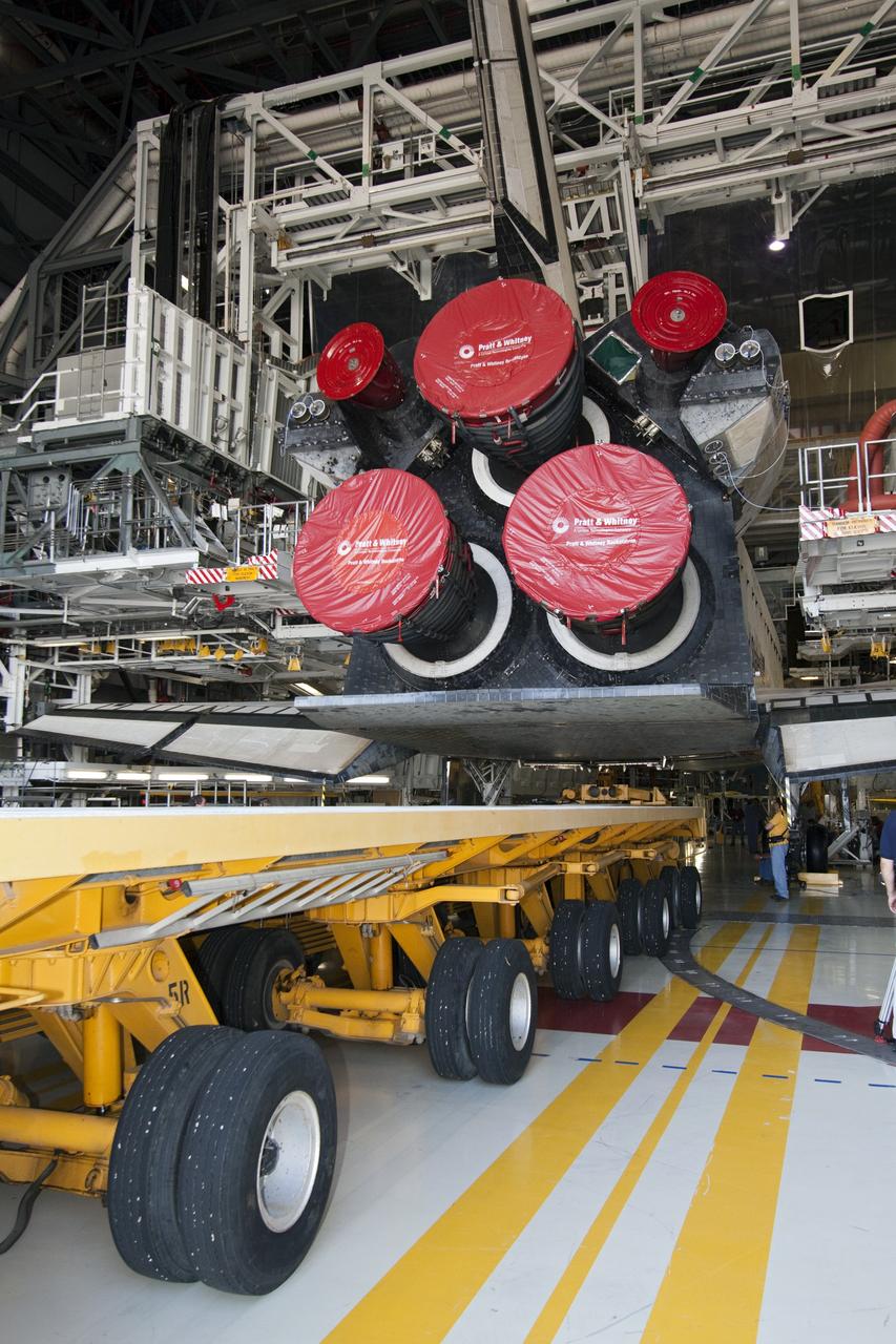 CAPE CANAVERAL, Fla. -- In Orbiter Processing Facility-1 at NASA's Kennedy Space Center in Florida, workers guide the Orbiter Transporter System (OTS) under shuttle Atlantis for its move, or rollover, to the nearby Vehicle Assembly Building (VAB).          Once inside the VAB, Atlantis will be joined to its solid rocket boosters and external fuel tank on the mobile launcher platform. Later this month, Atlantis is scheduled to "rollout" to Launch Pad 39A on the STS-135 mission, which will deliver the Raffaello multi-purpose logistics module packed with supplies and spare parts to the International Space Station. STS-135, targeted to launch June 28, will be the 33rd flight of Atlantis, the 37th shuttle mission to the station, and the 135th and final mission of NASA's Space Shuttle Program. For more information, visit www.nasa.gov/mission_pages/shuttle/shuttlemissions/sts135/index.html. NASA/Jack Pfaller
