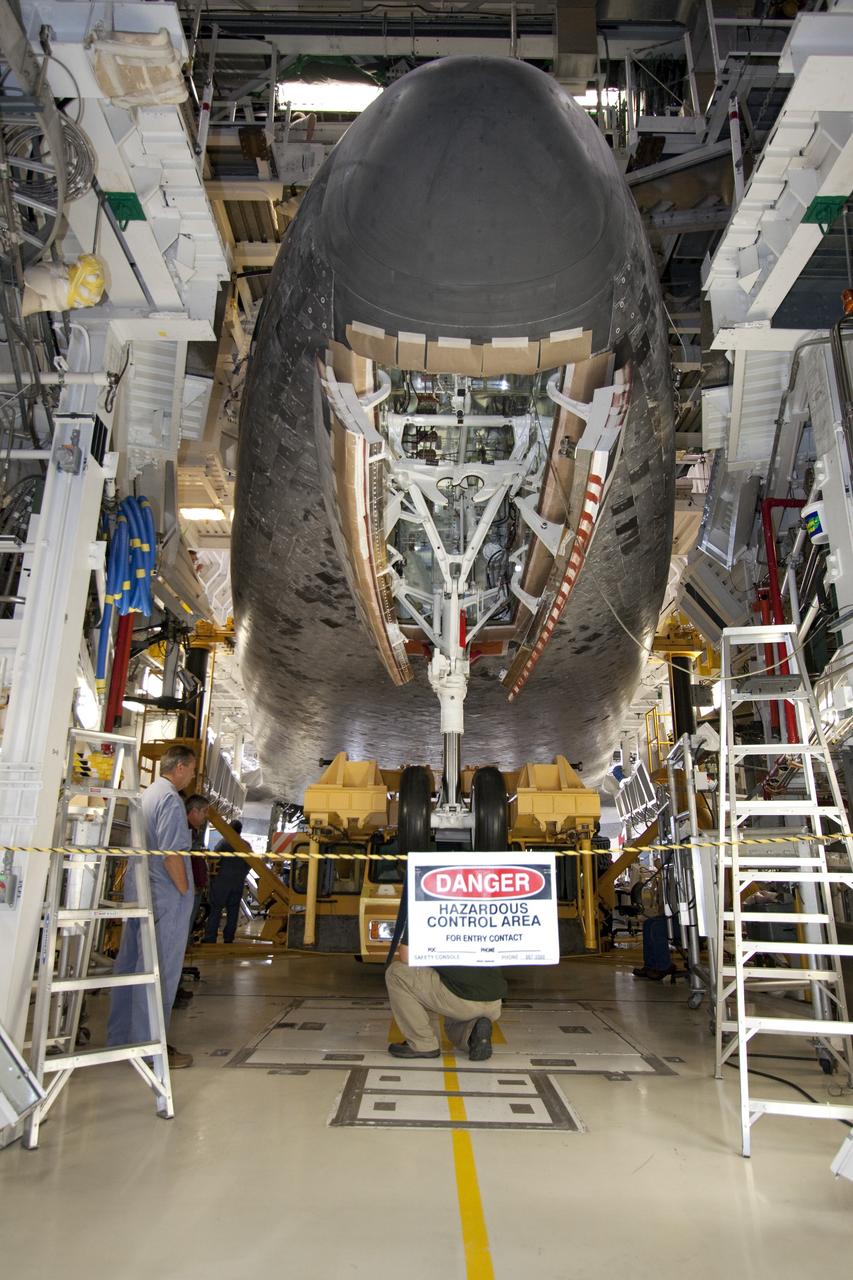 CAPE CANAVERAL, Fla. -- In Orbiter Processing Facility-1 at NASA's Kennedy Space Center in Florida, workers secure the Orbiter Transporter System (OTS) to shuttle Atlantis for its move, or rollover, to the nearby Vehicle Assembly Building (VAB).        Once inside the VAB, Atlantis will be joined to its solid rocket boosters and external fuel tank on the mobile launcher platform. Later this month, Atlantis is scheduled to "rollout" to Launch Pad 39A on the STS-135 mission, which will deliver the Raffaello multi-purpose logistics module packed with supplies and spare parts to the International Space Station. STS-135, targeted to launch June 28, will be the 33rd flight of Atlantis, the 37th shuttle mission to the station, and the 135th and final mission of NASA's Space Shuttle Program. For more information, visit www.nasa.gov/mission_pages/shuttle/shuttlemissions/sts135/index.html. NASA/Jack Pfaller