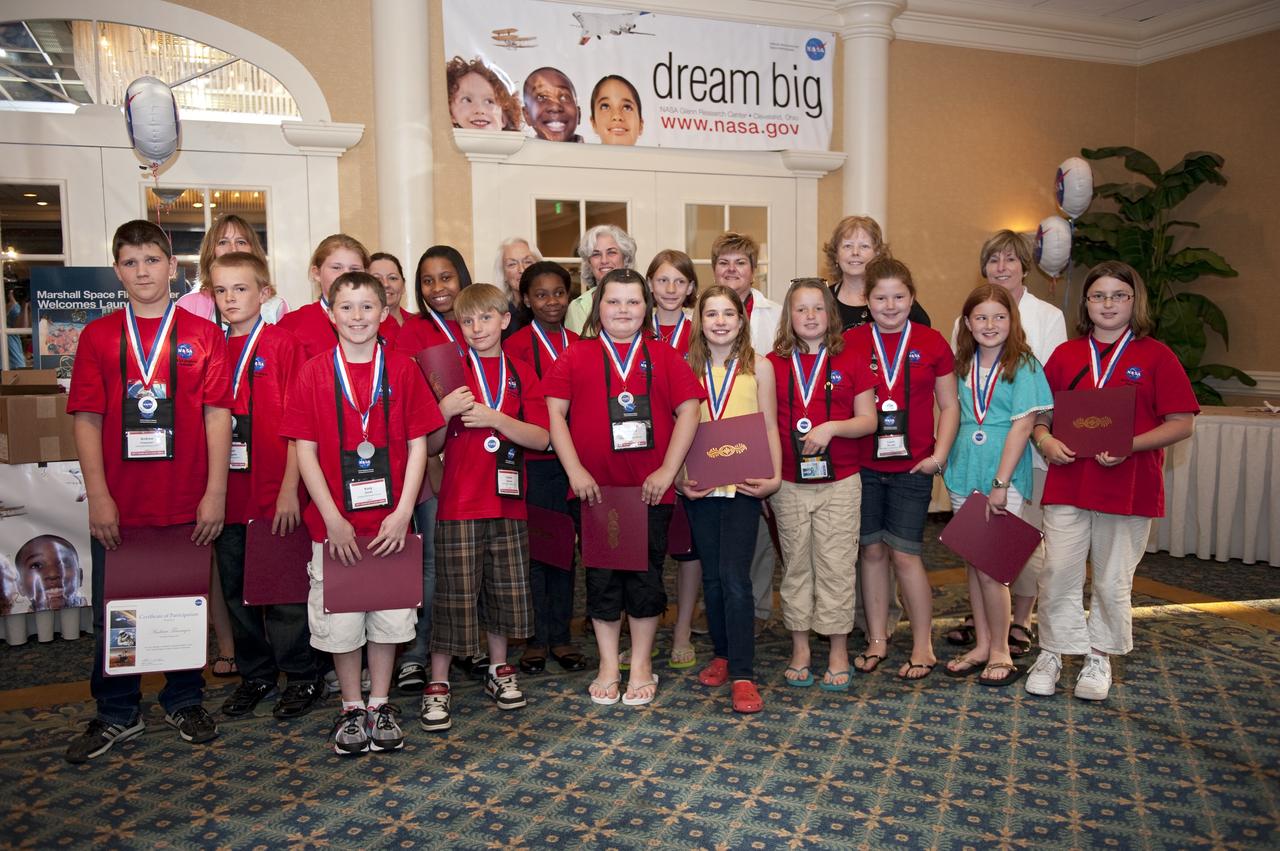 Cape Canaveral, Fla. -- Students and teachers from across the nation gathered for a photo opportunity during closing events of the NASA Explorer Schools (NES) symposium.             During the NES gathering, students presented their investigation project to their peers, scientists, engineers and education specialists. About 60 fourth- through 12-grade students nationwide are at the center May 4-7 participating in tours of processing and launch facilities and the U.S. Astronaut Hall of Fame, as well as several educational activities and a career panel question-and-answer session. About 30 teachers will receive professional development opportunities during the symposium. The participants were competitively selected after they completed an original investigation focused on existing NASA missions or research interests. Photo Credit: NASA/Kim Shiflett