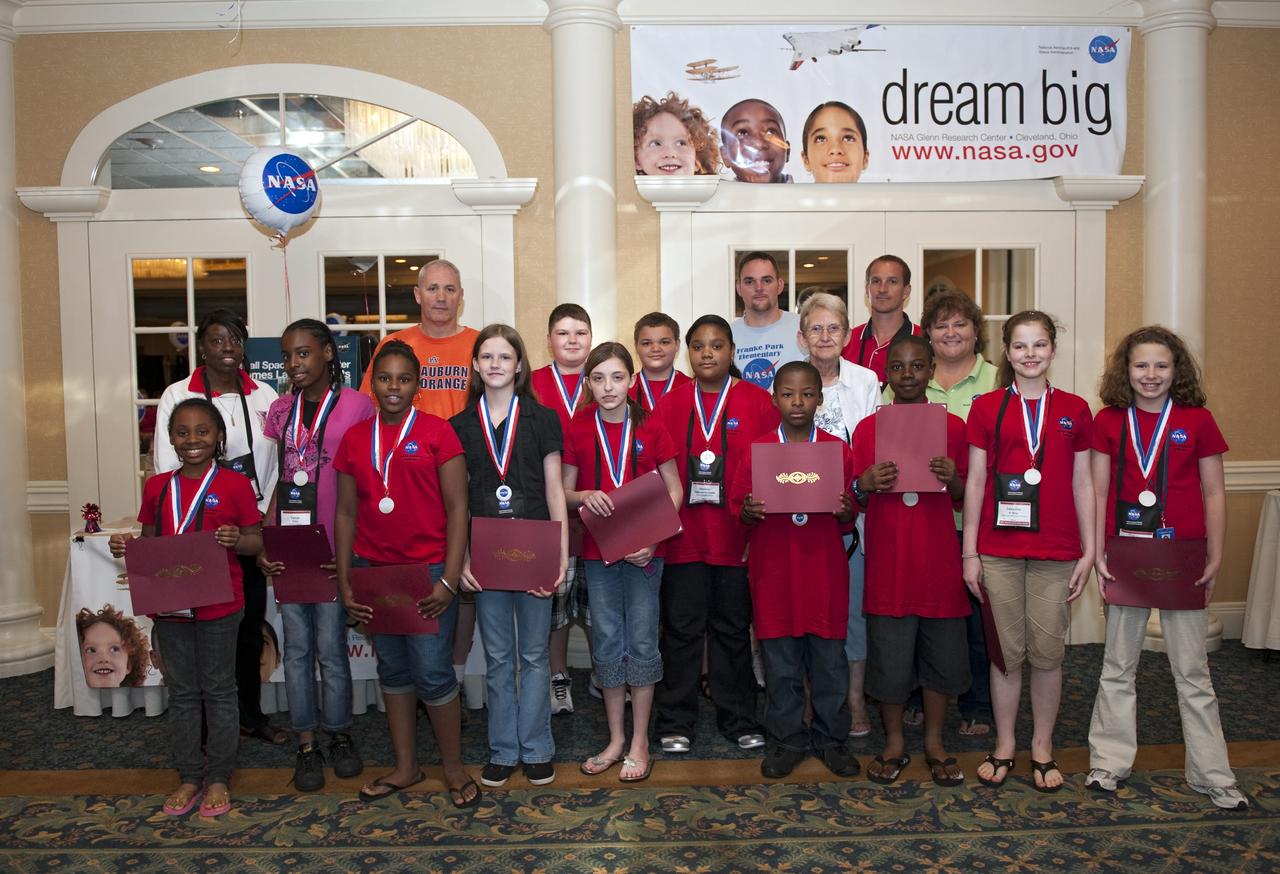 Cape Canaveral, Fla. -- Students and teachers from across the nation gathered for a photo opportunity during closing events of the NASA Explorer Schools (NES) symposium.             During the NES gathering, students presented their investigation project to their peers, scientists, engineers and education specialists. About 60 fourth- through 12-grade students nationwide are at the center May 4-7 participating in tours of processing and launch facilities and the U.S. Astronaut Hall of Fame, as well as several educational activities and a career panel question-and-answer session. About 30 teachers will receive professional development opportunities during the symposium. The participants were competitively selected after they completed an original investigation focused on existing NASA missions or research interests. Photo Credit: NASA/Kim Shiflett