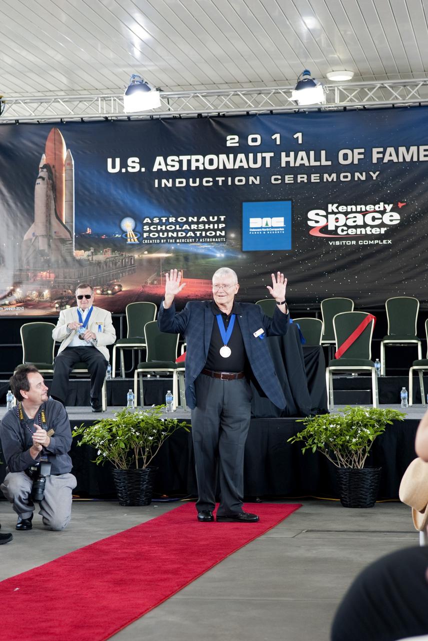 Cape Canaveral, Fla. -- Hall of Fame astronaut Fred Haise thanks the audience for their applause at the 2011 U.S. Astronaut Hall of Fame induction ceremony at NASA's Kennedy Space Center Visitor Complex in Florida.          Hall of Fame astronauts and visitors gathered to honor 2011 inductees Karol "Bo" Bobko and Susan Helms. During his 19 years in the astronaut program, Bobko flew on three space shuttle missions and logged more than 386 hours in space. He served as pilot during the first voyage of space shuttle Challenger aboard STS-6 in April 1983 and as commander during the maiden flight of space shuttle Atlantis aboard STS-51J in October 1985. Helms, a five-time space shuttle astronaut, has logged 5,064 hours in space. During her stay onboard the International Space Station as a member of the Expedition-2 crew in 2001, Helms performed a world record 8 hour and 56 minute spacewalk. Bobko and Helms join the ranks of the U.S. Astronaut Hall of Fame bringing the number of space explorers enshrined in the Hall of Fame to 79. Photo Credit: NASA/Jim Grossmann