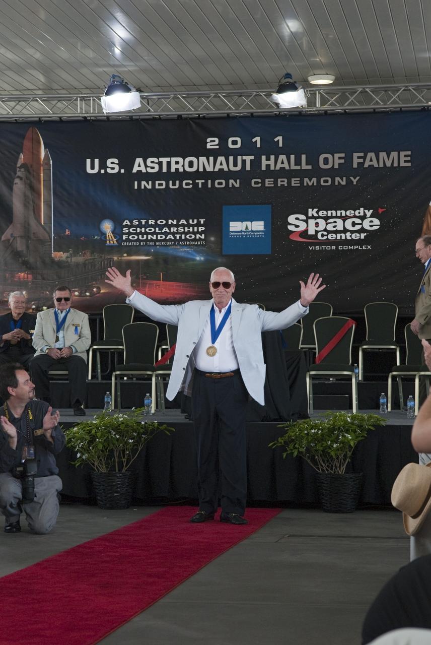 Cape Canaveral, Fla. -- Hall of Fame astronaut Al Worden thanks the audience for their applause at the 2011 U.S. Astronaut Hall of Fame induction ceremony at NASA's Kennedy Space Center Visitor Complex in Florida.            Hall of Fame astronauts and visitors gathered to honor 2011 inductees Karol "Bo" Bobko and Susan Helms. During his 19 years in the astronaut program, Bobko flew on three space shuttle missions and logged more than 386 hours in space. He served as pilot during the first voyage of space shuttle Challenger aboard STS-6 in April 1983 and as commander during the maiden flight of space shuttle Atlantis aboard STS-51J in October 1985. Helms, a five-time space shuttle astronaut, has logged 5,064 hours in space. During her stay onboard the International Space Station as a member of the Expedition-2 crew in 2001, Helms performed a world record 8 hour and 56 minute spacewalk. Bobko and Helms join the ranks of the U.S. Astronaut Hall of Fame bringing the number of space explorers enshrined in the Hall of Fame to 79. Photo Credit: NASA/Jim Grossmann