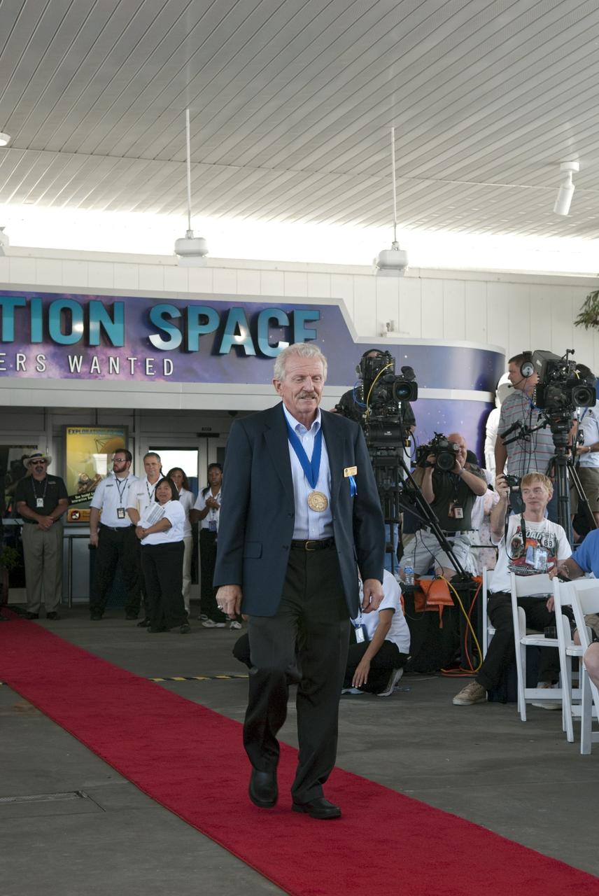 Cape Canaveral, Fla. -- Hall of Fame astronaut Rick Hauck is warmly greeted at the 2011 U.S. Astronaut Hall of Fame induction ceremony at NASA's Kennedy Space Center Visitor Complex in Florida.        Hall of Fame astronauts and visitors gathered to honor 2011 inductees Karol "Bo" Bobko and Susan Helms. During his 19 years in the astronaut program, Bobko flew on three space shuttle missions and logged more than 386 hours in space. He served as pilot during the first voyage of space shuttle Challenger aboard STS-6 in April 1983 and as commander during the maiden flight of space shuttle Atlantis aboard STS-51J in October 1985. Helms, a five-time space shuttle astronaut, has logged 5,064 hours in space. During her stay onboard the International Space Station as a member of the Expedition-2 crew in 2001, Helms performed a world record 8 hour and 56 minute spacewalk. Bobko and Helms join the ranks of the U.S. Astronaut Hall of Fame bringing the number of space explorers enshrined in the Hall of Fame to 79. Photo Credit: NASA/Jim Grossmann