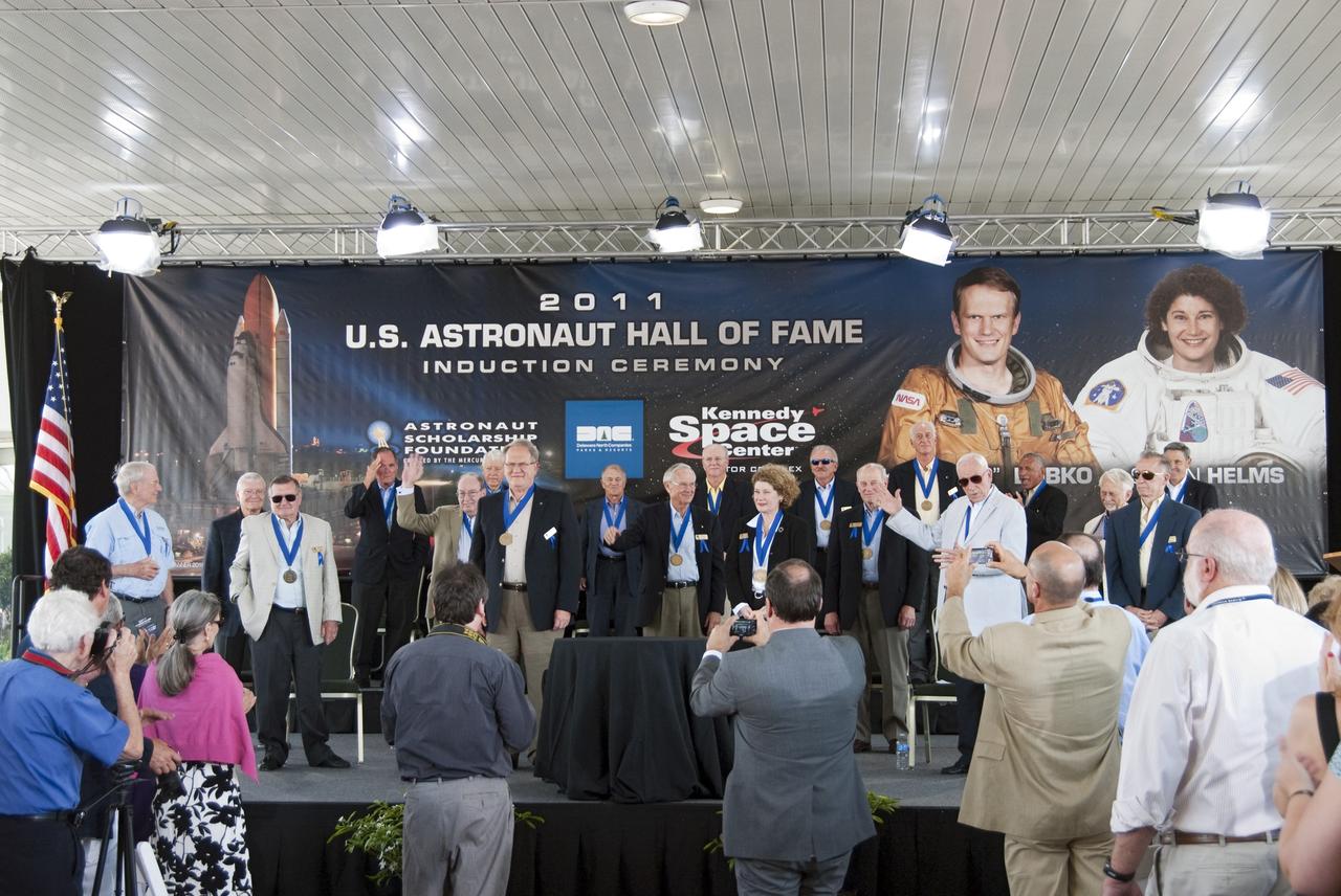 Cape Canaveral, Fla. -- At NASA's Kennedy Space Center Visitor Complex in Florida, the audiences applauds Karol "Bo" Bobko and Susan Helms after their induction into the U.S. Astronaut Hall of Fame.      Hall of Fame astronauts and visitors gathered to honor 2011 inductees Karol "Bo" Bobko and Susan Helms. During his 19 years in the astronaut program, Bobko flew on three space shuttle missions and logged more than 386 hours in space. He served as pilot during the first voyage of space shuttle Challenger aboard STS-6 in April 1983 and as commander during the maiden flight of space shuttle Atlantis aboard STS-51J in October 1985. Helms, a five-time space shuttle astronaut, has logged 5,064 hours in space. During her stay onboard the International Space Station as a member of the Expedition-2 crew in 2001, Helms performed a world record 8 hour and 56 minute spacewalk. Bobko and Helms join the ranks of the U.S. Astronaut Hall of Fame bringing the number of space explorers enshrined in the Hall of Fame to 79. Photo Credit: NASA/Jim Grossmann