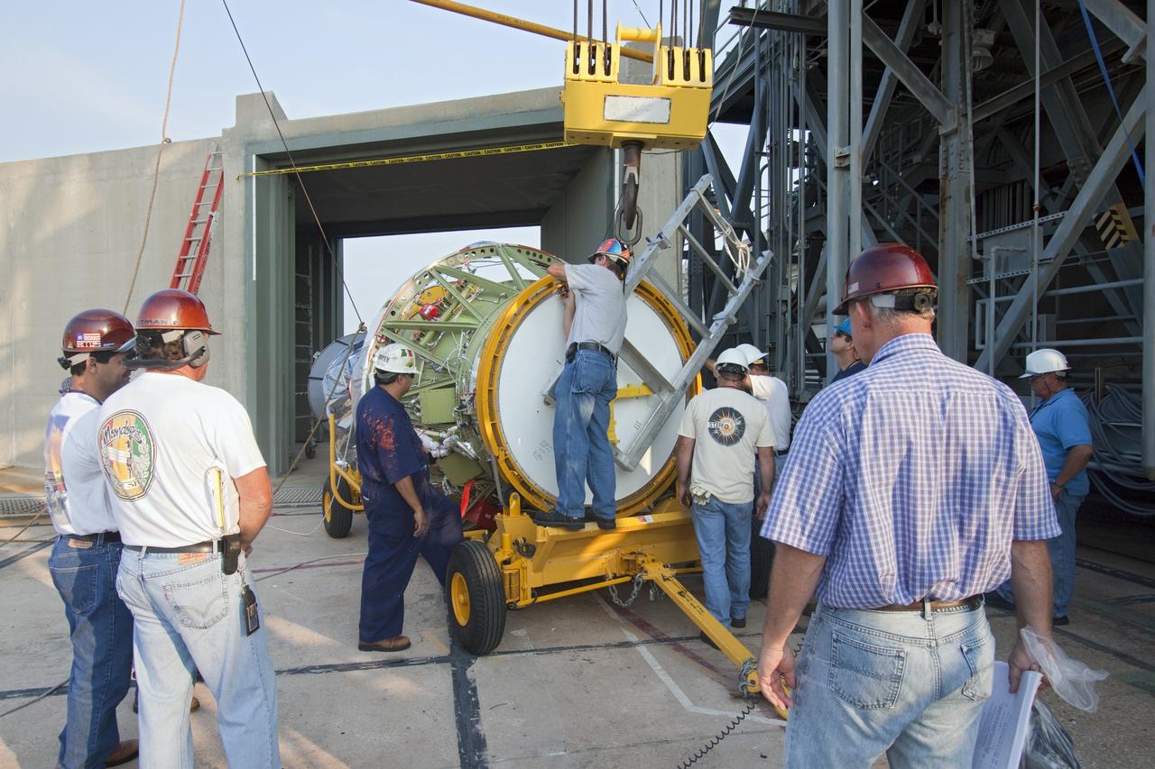CAPE CANAVERAL, Fla. -- At NASA's Space Launch Complex 17B in Florida, workers attach an overhead crane to the second stage of a United Launch Alliance Delta II launch vehicle. It will then be hoisted atop the first stage for mating. The Delta II will carry NASA's Gravity Recovery and Interior Laboratory, or GRAIL, spacecraft into lunar orbit. The GRAIL mission is a part of NASA's Discovery Program. GRAIL will fly twin spacecraft in tandem orbits around the moon for several months to measure its gravity field. The mission also will answer longstanding questions about Earth's moon and provide scientists a better understanding of how Earth and other rocky planets in the solar system formed. GRAIL is scheduled to launch Sept. 8. For more information visit: http://science.nasa.gov/missions/grail/. Photo credit: NASA/Jack Pfaller