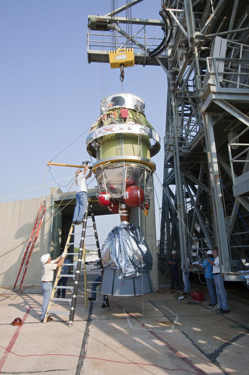 CAPE CANAVERAL, Fla. -- At NASA's Space Launch Complex 17B in Florida, workers using an overhead crane hoist the second stage of a United Launch Alliance Delta II launch vehicle toward the first stage for mating. The payload fairing then will be raised into the white room of the mobile service tower. The Delta II will carry NASA's Gravity Recovery and Interior Laboratory, or GRAIL, spacecraft into lunar orbit. The GRAIL mission is a part of NASA's Discovery Program. GRAIL will fly twin spacecraft in tandem orbits around the moon for several months to measure its gravity field. The mission also will answer longstanding questions about Earth's moon and provide scientists a better understanding of how Earth and other rocky planets in the solar system formed. GRAIL is scheduled to launch Sept. 8. For more information visit: http://science.nasa.gov/missions/grail/. Photo credit: NASA/Jack Pfaller