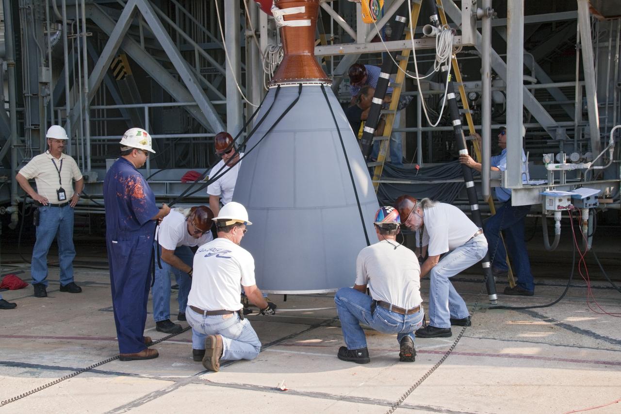 CAPE CANAVERAL, Fla. -- At NASA's Space Launch Complex 17B in Florida, workers secure the engine bell on the second stage of a United Launch Alliance Delta II launch vehicle before it is hoisted into the mobile service tower. The Delta II will carry NASA's Gravity Recovery and Interior Laboratory, or GRAIL, spacecraft into lunar orbit. The GRAIL mission is a part of NASA's Discovery Program. GRAIL will fly twin spacecraft in tandem orbits around the moon for several months to measure its gravity field. The mission also will answer longstanding questions about Earth's moon and provide scientists a better understanding of how Earth and other rocky planets in the solar system formed. GRAIL is scheduled to launch Sept. 8. For more information visit: http://science.nasa.gov/missions/grail/. Photo credit: NASA/Jack Pfaller