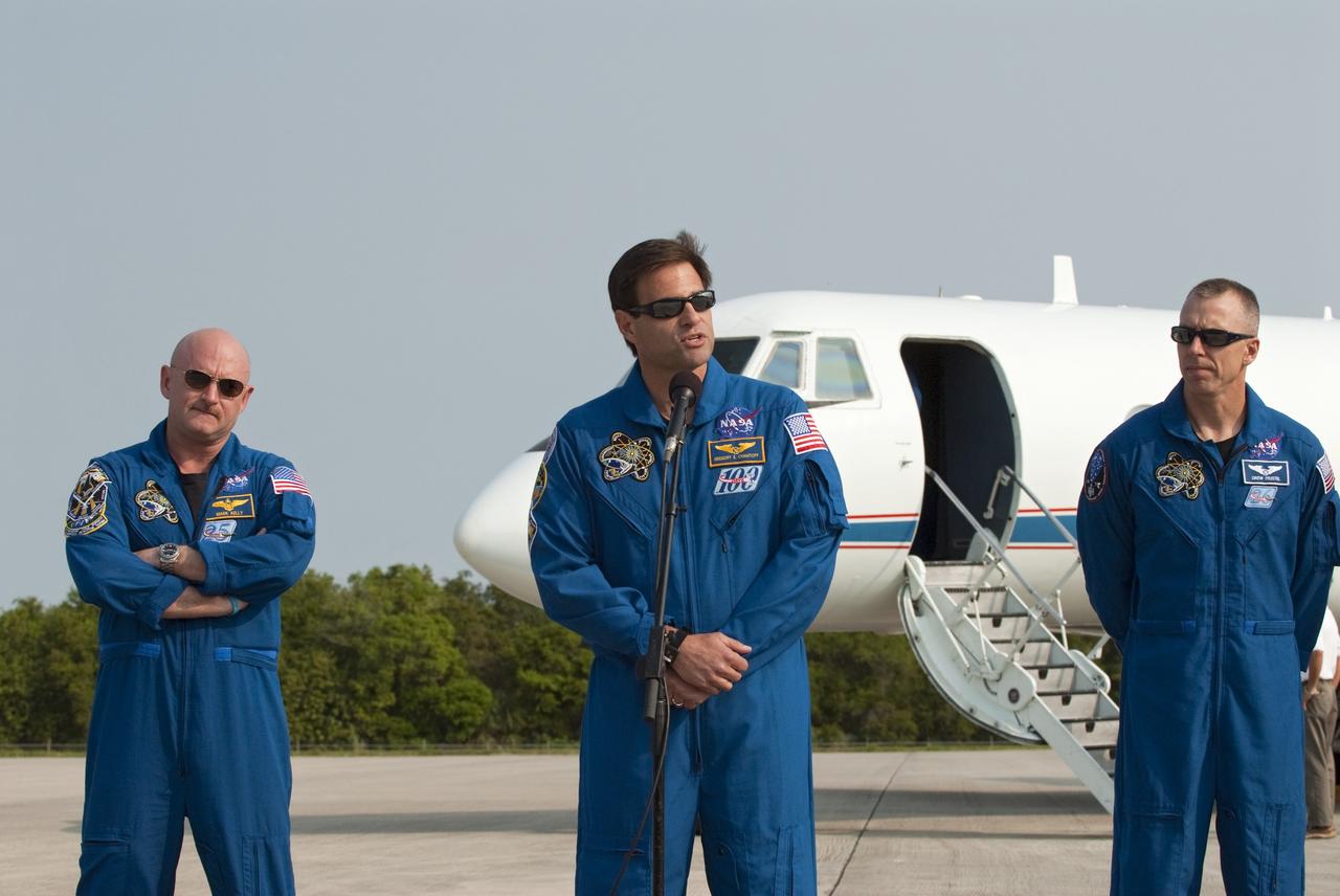 CAPE CANAVERAL, Fla. -- At the Shuttle Landing Facility at NASA's Kennedy Space Center in Florida, STS-134 Mission Specialist Greg Chamitoff is photographed as he speaks to media while Commander Mark Kelly (left) and Mission Specialist Andrew Fuestel look on. The STS-134 crew members landed at about 9 a.m. EDT for final preparations for Endeavour's liftoff to the International Space Station scheduled for Monday, May 16 at 8:56 a.m. Endeavour and its crew will deliver the Express Logistics Carrier-3, Alpha Magnetic Spectrometer-2 (AMS), a high-pressure gas tank and additional spare parts for the Dextre robotic helper to the station. This will be the final spaceflight for Endeavour. For more information visit, www.nasa.gov/mission_pages/shuttle/shuttlemissions/sts134/index.html. Photo credit: NASA/Kim Shiflett