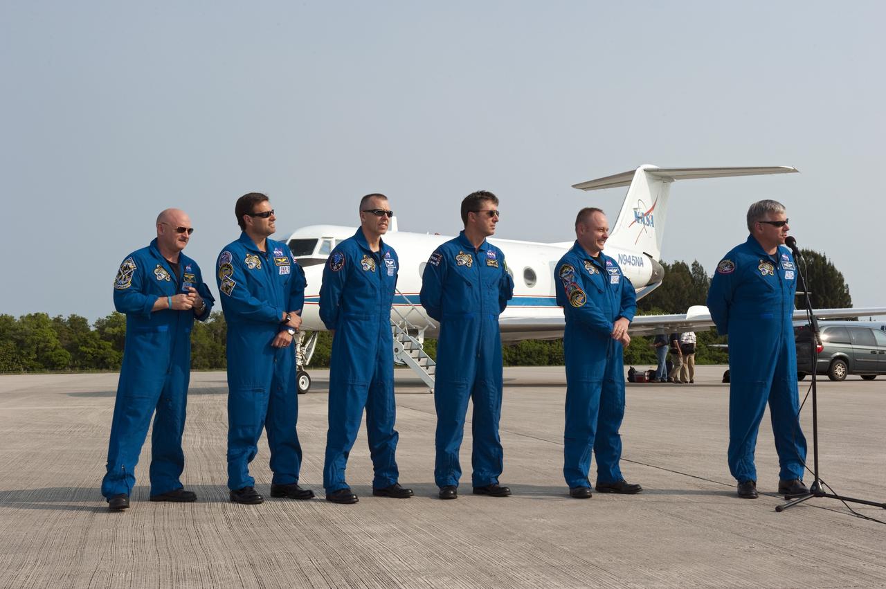 CAPE CANAVERAL, Fla. -- The STS-134 crew members arrived on the Shuttle Landing Facility at NASA's Kennedy Space Center in Florida at about 9 a.m. EDT to get ready for space shuttle Endeavour's launch to the International Space Station scheduled for Monday, May 16 at 8:56 a.m. From left are Commander Mark Kelly, Mission Specialists Greg Chamitoff, Andrew Feustel, European Space Agency astronaut Roberto Vittori, Michael Fincke and Pilot Greg H. Johnson, at the microphone.            Endeavour and its crew will deliver the Express Logistics Carrier-3, Alpha Magnetic Spectrometer-2 (AMS), a high-pressure gas tank and additional spare parts for the Dextre robotic helper to the station. This will be the final spaceflight for Endeavour. For more information visit, www.nasa.gov/mission_pages/shuttle/shuttlemissions/sts134/index.html. Photo credit: NASA/Kim Shiflett