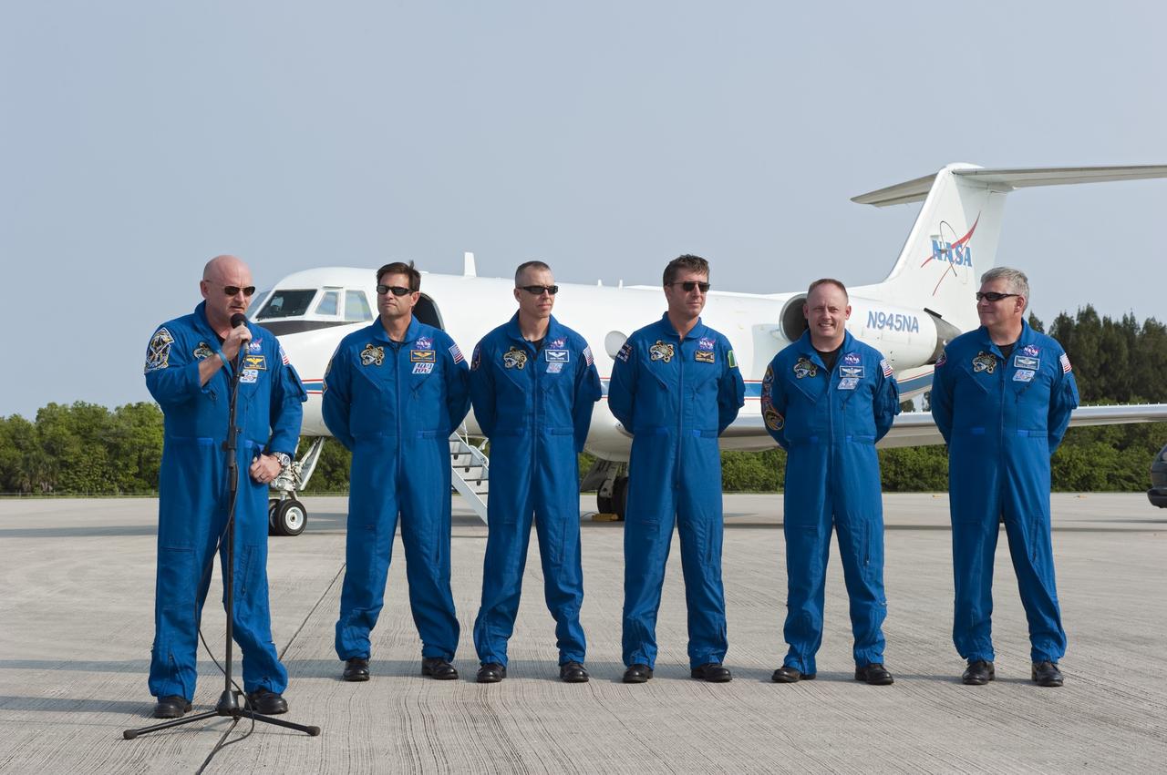 CAPE CANAVERAL, Fla. -- The STS-134 crew members arrived on the Shuttle Landing Facility at NASA's Kennedy Space Center in Florida at about 9 a.m. EDT to get ready for space shuttle Endeavour's launch to the International Space Station scheduled for Monday, May 16 at 8:56 a.m. From left are Commander Mark Kelly, at the microphone, Mission Specialists Greg Chamitoff, Andrew Feustel, European Space Agency astronaut Roberto Vittori, Michael Fincke and Pilot Greg H. Johnson.    Endeavour and its crew will deliver the Express Logistics Carrier-3, Alpha Magnetic Spectrometer-2 (AMS), a high-pressure gas tank and additional spare parts for the Dextre robotic helper to the station. This will be the final spaceflight for Endeavour. For more information visit, www.nasa.gov/mission_pages/shuttle/shuttlemissions/sts134/index.html. Photo credit: NASA/Kim Shiflett
