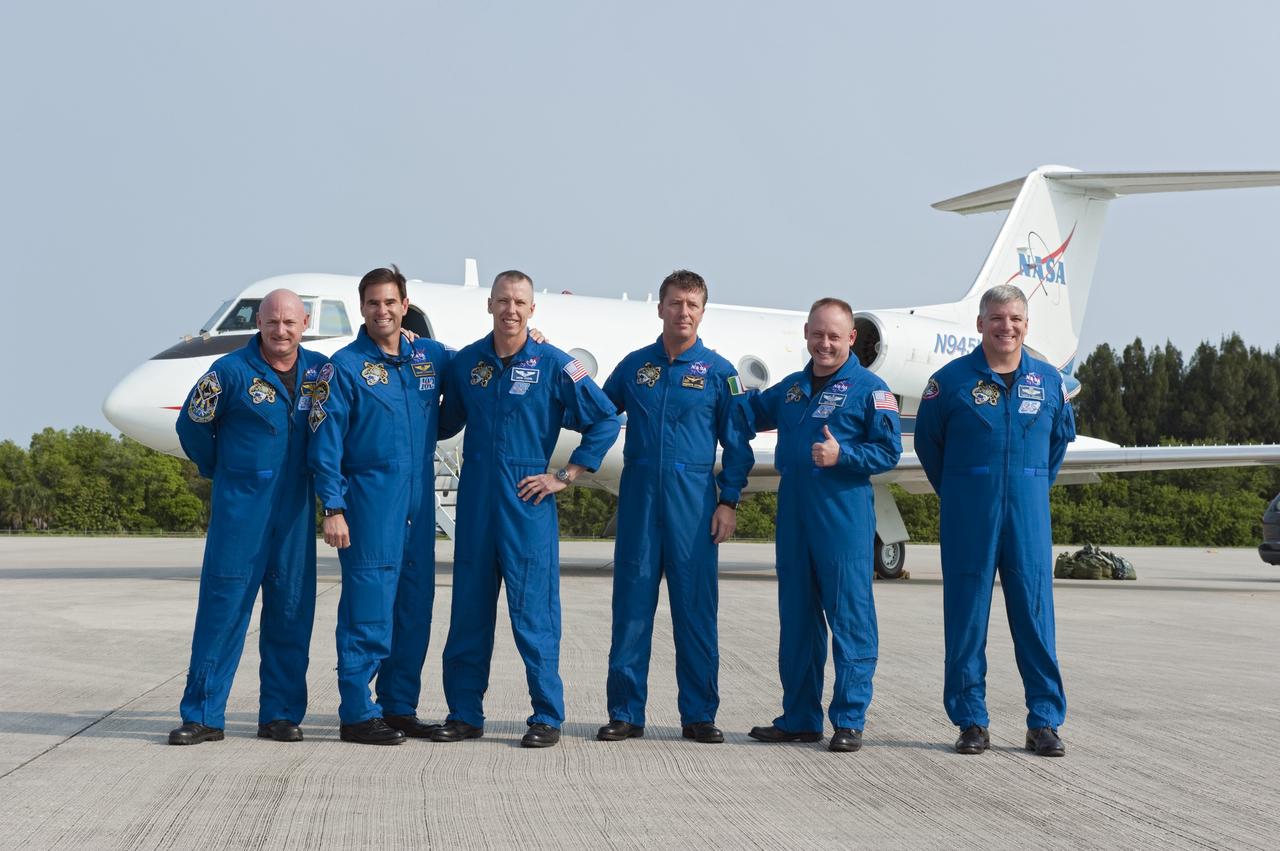 CAPE CANAVERAL, Fla. -- The six STS-134 astronauts pause for a photo after arrival at NASA Kennedy Space Center's Shuttle Landing Facility in Florida, to begin final launch preparations for space shuttle Endeavour's mission to the International Space Station scheduled for Monday, May 16 at 8:56 a.m. From left are Commander Mark Kelly, Mission Specialists Greg Chamitoff, Andrew Feustel, European Space Agency astronaut Roberto Vittori,Michael Fincke and Pilot Greg H. Johnson.  Endeavour and its crew will deliver the Express Logistics Carrier-3, Alpha Magnetic Spectrometer-2 (AMS), a high-pressure gas tank and additional spare parts for the Dextre robotic helper to the station. This will be the final spaceflight for Endeavour. For more information visit, www.nasa.gov/mission_pages/shuttle/shuttlemissions/sts134/index.html. Photo credit: NASA/Kim Shiflett