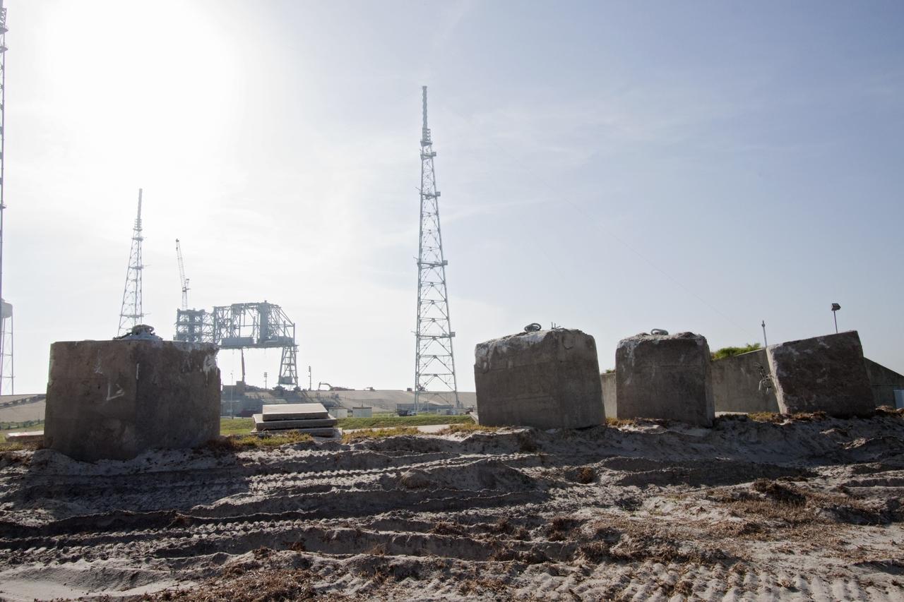 Cape Canaveral, Fla. -- Photographed from the base of the former emergency egress system at NASA's Kennedy Space Center in Florida, is the skeleton of steel that once was Launch Pad 39B after significant deconstruction. The system included seven baskets suspended from seven slidewires that extended from the pad to a landing zone 1,200 feet west of the pad. The bunkers at the base also are being dismantled.          In 2009, the pad was no longer needed for the shuttle program, so it is being restructured for future use. Its new design will feature a "clean pad" for rockets to come with their own launcher, making it more versatile for a number of vehicles. The new lightning protection system, which was in place for the October 2009 launch of Ares I-X, will remain. For information on NASA's future plans, visit www.nasa.gov. Photo credit: NASA/Jack Pfaller