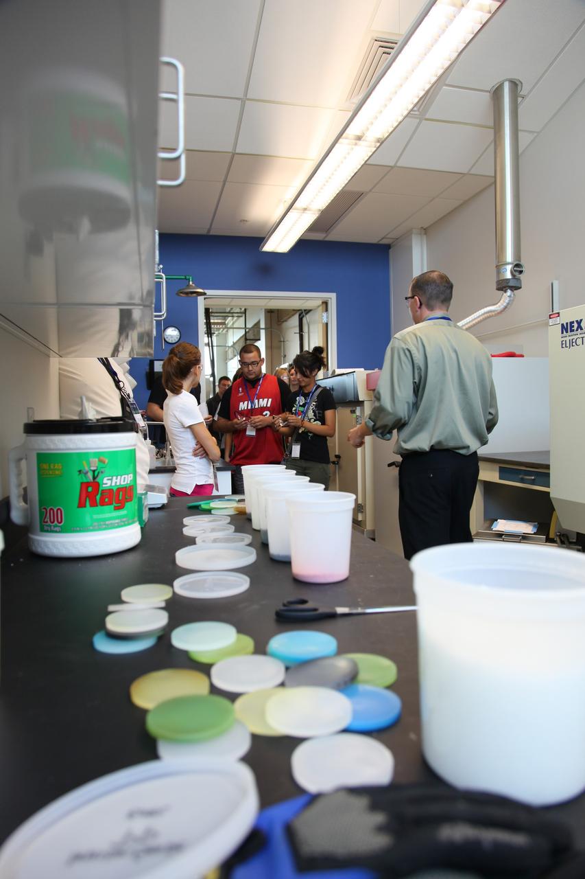 Cape Canaveral, Fla. -- Students participate in a hands-on activity as a laboratory technician looks on in Kennedy’s Space Life Sciences Laboratory (SLSL). High-school students from two Orlando, Fla., schools travelled to NASA’s Kennedy Space Center in Florida to participate in National Lab Day activities. During the event, about 80 students, toured various facilities and engaged in educational hands-on activities. National Lab Day is a partnership between federal agencies, foundations, professional societies and organizations devoted to promoting science, technology, engineering and math, or STEM, hands-on discovery-based laboratory experiences for students. Photo Credit: NASA/Frankie Martin