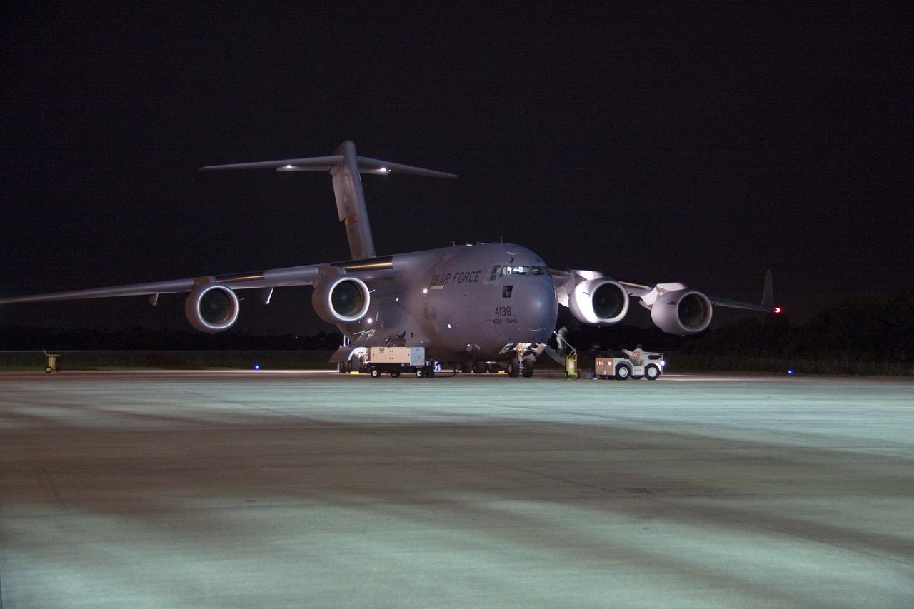 CAPE CANAVERAL, Fla. -- The first three elements for NASA's Mars Science Laboratory (MSL) arrive at NASA Kennedy Space Center's Shuttle Landing Facility aboard an Air Force C-17 cargo plane.       The cruise stage, back shell and heat shield, the first flight elements to arrive for the MSL mission, were taken to the Payload Hazardous Servicing Facility (PHSF) located in the KSC Industrial Area to begin processing. The Curiosity rover will arrive next month.     A United Launch Alliance Atlas V-541 configuration will be used to loft MSL into space. Curiosity’s 10 science instruments are designed to search for evidence on whether Mars has had environments favorable to microbial life, including chemical ingredients for life.  The unique rover will use a laser to look inside rocks and release its gasses so that the rover’s spectrometer can analyze and send the data back to Earth. MSL is scheduled to launch from Cape Canaveral Air Force Station in Florida Nov. 25 with a window extending to Dec. 18 and arrival at Mars Aug. 2012. For more information, visit http://www.nasa.gov/msl. Photo credit: NASA/Troy Cryder