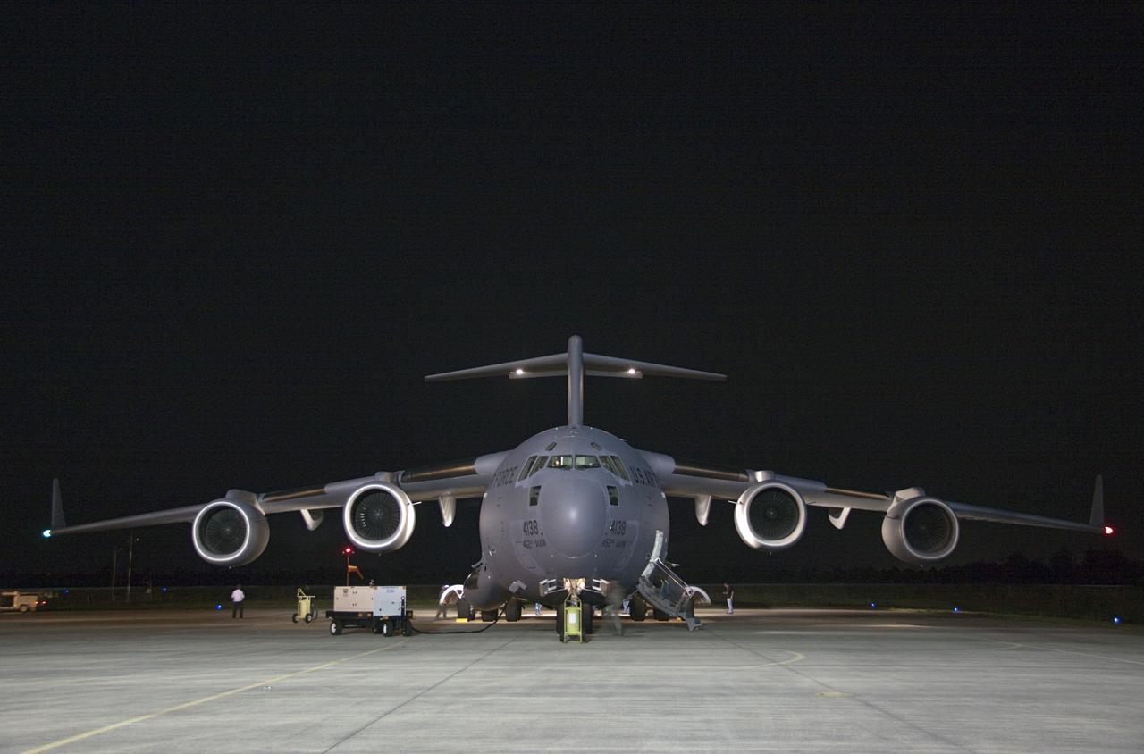 CAPE CANAVERAL, Fla. -- The first three elements for NASA's Mars Science Laboratory (MSL) arrive at NASA Kennedy Space Center's Shuttle Landing Facility aboard an Air Force C-17 cargo plane.       The cruise stage, back shell and heat shield, the first flight elements to arrive for the MSL mission, were taken to the Payload Hazardous Servicing Facility (PHSF) located in the KSC Industrial Area to begin processing. The Curiosity rover will arrive next month.    A United Launch Alliance Atlas V-541 configuration will be used to loft MSL into space. Curiosity’s 10 science instruments are designed to search for evidence on whether Mars has had environments favorable to microbial life, including chemical ingredients for life.  The unique rover will use a laser to look inside rocks and release its gasses so that the rover’s spectrometer can analyze and send the data back to Earth. MSL is scheduled to launch from Cape Canaveral Air Force Station in Florida Nov. 25 with a window extending to Dec. 18 and arrival at Mars Aug. 2012. For more information, visit http://www.nasa.gov/msl. Photo credit: NASA/Troy Cryder