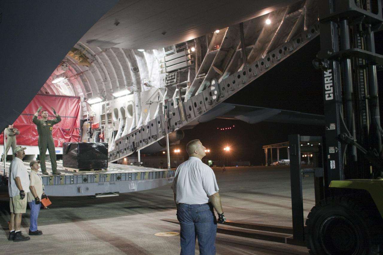 CAPE CANAVERAL, Fla. -- Workers begin to unload the first elements for NASA's Mars Science Laboratory (MSL) payload after arrival at NASA Kennedy Space Center's Shuttle Landing Facility aboard an Air Force C-17 cargo plane.       The cruise stage, back shell and heat shield, the first flight elements to arrive for the MSL mission, were taken to the Payload Hazardous Servicing Facility (PHSF) located in the KSC Industrial Area to begin processing. The Curiosity rover will arrive next month.     A United Launch Alliance Atlas V-541 configuration will be used to loft MSL into space. Curiosity’s 10 science instruments are designed to search for evidence on whether Mars has had environments favorable to microbial life, including chemical ingredients for life.  The unique rover will use a laser to look inside rocks and release its gasses so that the rover’s spectrometer can analyze and send the data back to Earth. MSL is scheduled to launch from Cape Canaveral Air Force Station in Florida Nov. 25 with a window extending to Dec. 18 and arrival at Mars Aug. 2012. For more information, visit http://www.nasa.gov/msl. Photo credit: NASA/Troy Cryder