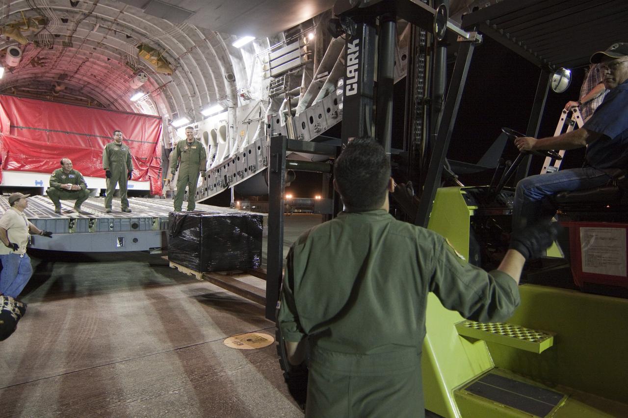 CAPE CANAVERAL, Fla. -- Workers begin to unload the first elements for NASA's Mars Science Laboratory (MSL) payload after arrival at NASA Kennedy Space Center's Shuttle Landing Facility aboard an Air Force C-17 cargo plane.       The cruise stage, back shell and heat shield, the first flight elements to arrive for the MSL mission, were taken to the Payload Hazardous Servicing Facility (PHSF) located in the KSC Industrial Area to begin processing. The Curiosity rover will arrive next month.     A United Launch Alliance Atlas V-541 configuration will be used to loft MSL into space. Curiosity’s 10 science instruments are designed to search for evidence on whether Mars has had environments favorable to microbial life, including chemical ingredients for life.  The unique rover will use a laser to look inside rocks and release its gasses so that the rover’s spectrometer can analyze and send the data back to Earth. MSL is scheduled to launch from Cape Canaveral Air Force Station in Florida Nov. 25 with a window extending to Dec. 18 and arrival at Mars Aug. 2012. For more information, visit http://www.nasa.gov/msl. Photo credit: NASA/Troy Cryder