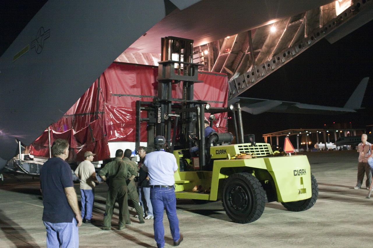 CAPE CANAVERAL, Fla. -- Workers unload a container holding the heat shield, one of the first three elements for NASA's Mars Science Laboratory (MSL) that arrived at NASA Kennedy Space Center's Shuttle Landing Facility aboard an Air Force C-17 cargo plane.       The cruise stage, back shell and heat shield, the first flight elements to arrive for the MSL mission, were taken to the Payload Hazardous Servicing Facility (PHSF) located in the KSC Industrial Area to begin processing. The Curiosity rover will arrive next month.    A United Launch Alliance Atlas V-541 configuration will be used to loft MSL into space. Curiosity’s 10 science instruments are designed to search for evidence on whether Mars has had environments favorable to microbial life, including chemical ingredients for life.  The unique rover will use a laser to look inside rocks and release its gasses so that the rover’s spectrometer can analyze and send the data back to Earth. MSL is scheduled to launch from Cape Canaveral Air Force Station in Florida Nov. 25 with a window extending to Dec. 18 and arrival at Mars Aug. 2012. For more information, visit http://www.nasa.gov/msl. Photo credit: NASA/Troy Cryder