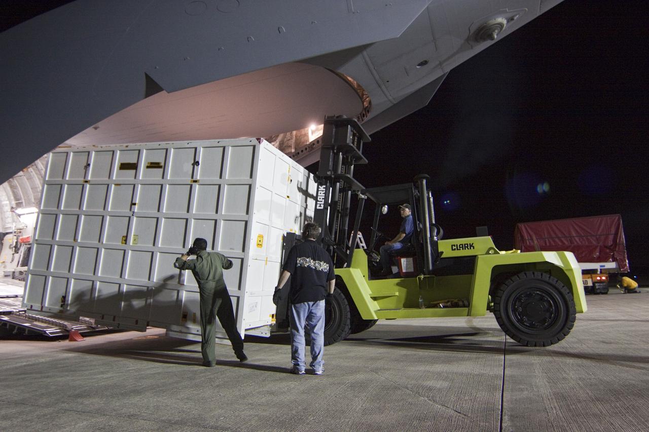 CAPE CANAVERAL, Fla. -- Workers unload a container holding the back shell, one of the first three elements for NASA's Mars Science Laboratory (MSL) that arrived at NASA Kennedy Space Center's Shuttle Landing Facility aboard an Air Force C-17 cargo plane.       The cruise stage, back shell and heat shield, the first flight elements to arrive for the MSL mission, were taken to the Payload Hazardous Servicing Facility (PHSF) located in the KSC Industrial Area to begin processing. The Curiosity rover will arrive next month.     A United Launch Alliance Atlas V-541 configuration will be used to loft MSL into space. Curiosity’s 10 science instruments are designed to search for evidence on whether Mars has had environments favorable to microbial life, including chemical ingredients for life.  The unique rover will use a laser to look inside rocks and release its gasses so that the rover’s spectrometer can analyze and send the data back to Earth. MSL is scheduled to launch from Cape Canaveral Air Force Station in Florida Nov. 25 with a window extending to Dec. 18 and arrival at Mars Aug. 2012. For more information, visit http://www.nasa.gov/msl. Photo credit: NASA/Troy Cryder