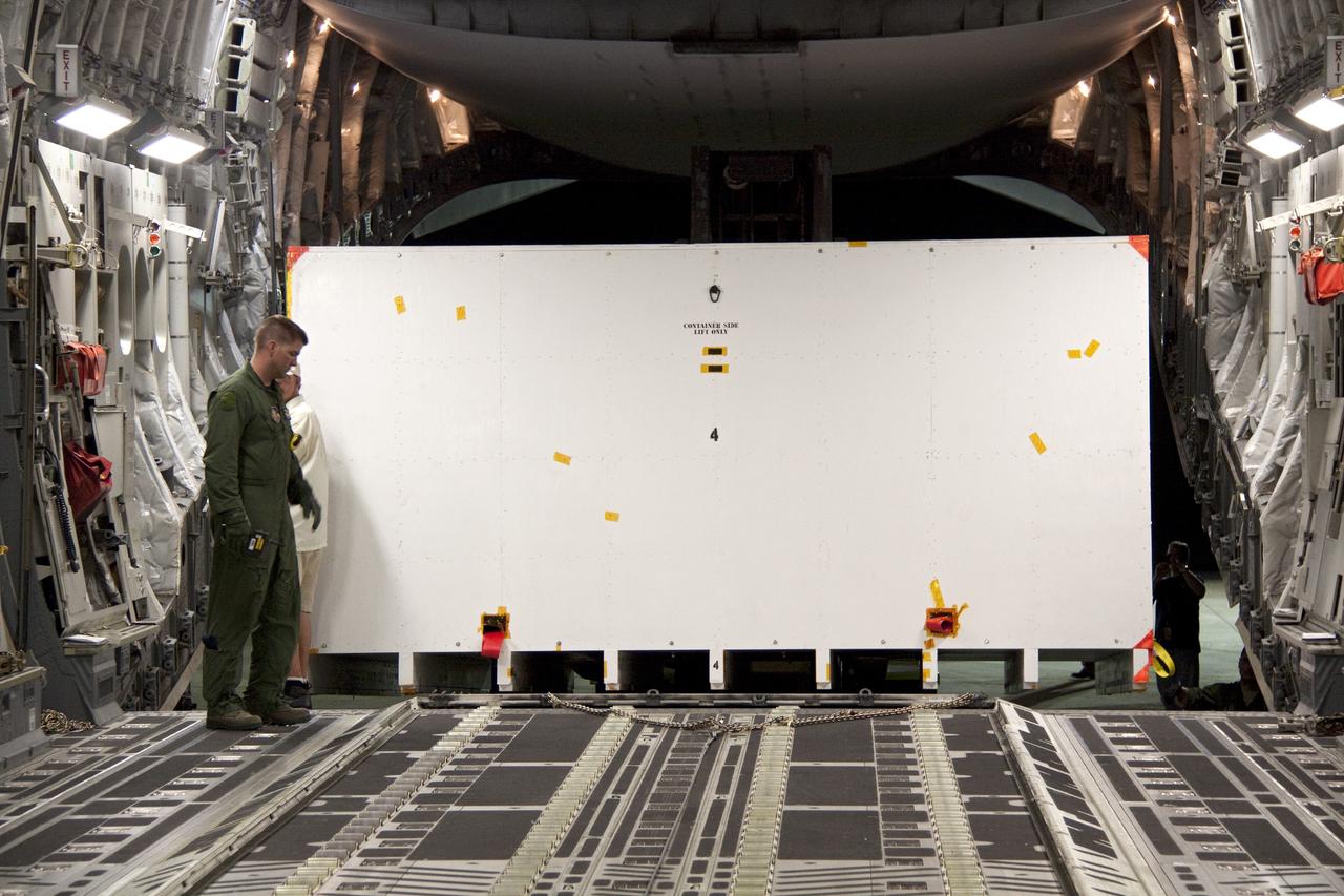 CAPE CANAVERAL, Fla. -- Workers unload a container holding the cruise stage, one of the first three elements for NASA's Mars Science Laboratory (MSL) that arrived at NASA Kennedy Space Center's Shuttle Landing Facility aboard an Air Force C-17 cargo plane.       The cruise stage, back shell and heat shield, the first flight elements to arrive for the MSL mission, were taken to the Payload Hazardous Servicing Facility (PHSF) located in the KSC Industrial Area to begin processing. The Curiosity rover will arrive next month.     A United Launch Alliance Atlas V-541 configuration will be used to loft MSL into space. Curiosity’s 10 science instruments are designed to search for evidence on whether Mars has had environments favorable to microbial life, including chemical ingredients for life.  The unique rover will use a laser to look inside rocks and release its gasses so that the rover’s spectrometer can analyze and send the data back to Earth. MSL is scheduled to launch from Cape Canaveral Air Force Station in Florida Nov. 25 with a window extending to Dec. 18 and arrival at Mars Aug. 2012. For more information, visit http://www.nasa.gov/msl. Photo credit: NASA/Troy Cryder
