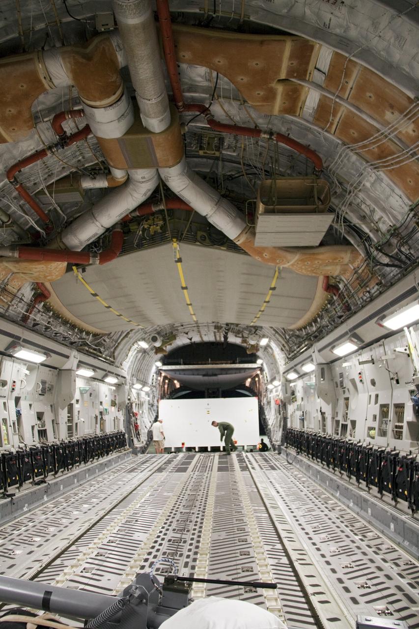 CAPE CANAVERAL, Fla. -- Workers unload a container holding the cruise stage, one of the first three elements for NASA's Mars Science Laboratory (MSL) that arrived at NASA Kennedy Space Center's Shuttle Landing Facility aboard an Air Force C-17 cargo plane.       The cruise stage, back shell and heat shield, the first flight elements to arrive for the MSL mission, were taken to the Payload Hazardous Servicing Facility (PHSF) located in the KSC Industrial Area to begin processing. The Curiosity rover will arrive next month.    A United Launch Alliance Atlas V-541 configuration will be used to loft MSL into space. Curiosity’s 10 science instruments are designed to search for evidence on whether Mars has had environments favorable to microbial life, including chemical ingredients for life.  The unique rover will use a laser to look inside rocks and release its gasses so that the rover’s spectrometer can analyze and send the data back to Earth. MSL is scheduled to launch from Cape Canaveral Air Force Station in Florida Nov. 25 with a window extending to Dec. 18 and arrival at Mars Aug. 2012. For more information, visit http://www.nasa.gov/msl. Photo credit: NASA/Troy Cryder