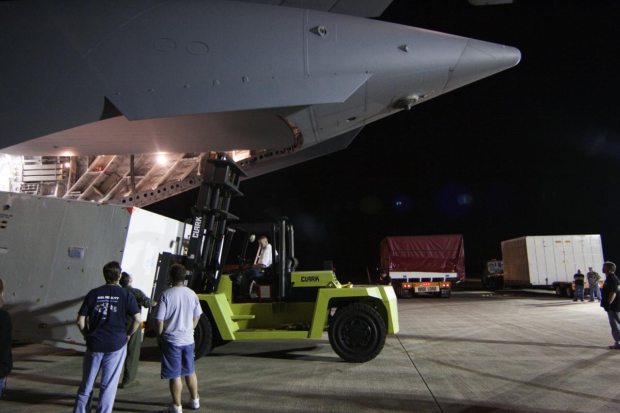 CAPE CANAVERAL, Fla. -- Workers unload a container holding the cruise stage, one of the first three elements for NASA's Mars Science Laboratory (MSL) that arrived at NASA Kennedy Space Center's Shuttle Landing Facility aboard an Air Force C-17 cargo plane.       The cruise stage, back shell and heat shield, the first flight elements to arrive for the MSL mission, were taken to the Payload Hazardous Servicing Facility (PHSF) located in the KSC Industrial Area to begin processing. The Curiosity rover will arrive next month.     A United Launch Alliance Atlas V-541 configuration will be used to loft MSL into space. Curiosity’s 10 science instruments are designed to search for evidence on whether Mars has had environments favorable to microbial life, including chemical ingredients for life.  The unique rover will use a laser to look inside rocks and release its gasses so that the rover’s spectrometer can analyze and send the data back to Earth. MSL is scheduled to launch from Cape Canaveral Air Force Station in Florida Nov. 25 with a window extending to Dec. 18 and arrival at Mars Aug. 2012. For more information, visit http://www.nasa.gov/msl. Photo credit: NASA/Troy Cryder