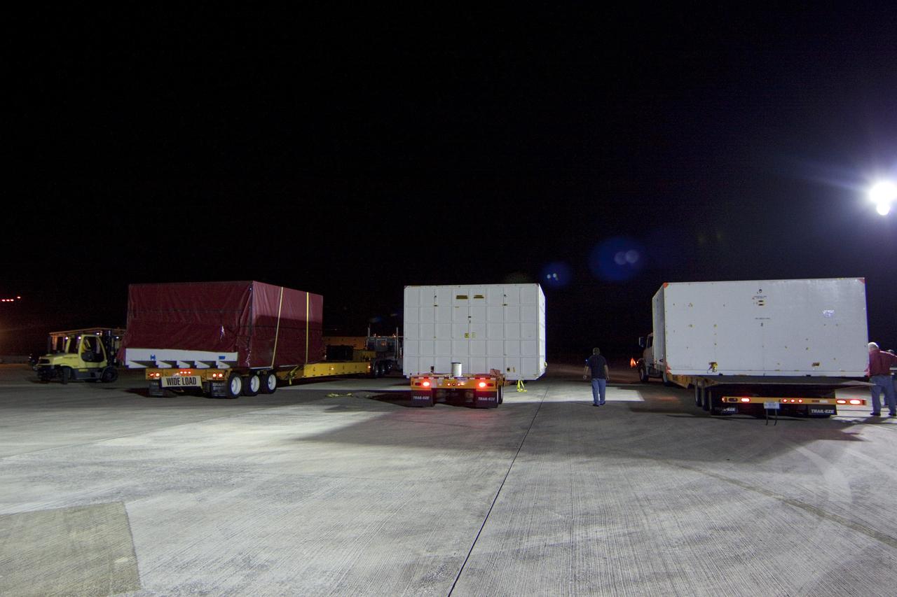 CAPE CANAVERAL, Fla. -- Workers have loaded onto a transporter all three containers holding the first three elements for NASA's Mars Science Laboratory (MSL) that arrived at NASA Kennedy Space Center's Shuttle Landing Facility aboard an Air Force C-17 cargo plane.         The cruise stage, back shell and heat shield, the first flight elements to arrive for the MSL mission, were taken to the Payload Hazardous Servicing Facility (PHSF) located in the KSC Industrial Area to begin processing.     The Curiosity rover will arrive next month.     A United Launch Alliance Atlas V-541 configuration will be used to loft MSL into space. Curiosity’s 10 science instruments are designed to search for evidence on whether Mars has had environments favorable to microbial life, including chemical ingredients for life.  The unique rover will use a laser to look inside rocks and release its gasses so that the rover’s spectrometer can analyze and send the data back to Earth. MSL is scheduled to launch from Cape Canaveral Air Force Station in Florida Nov. 25 with a window extending to Dec. 18 and arrival at Mars Aug. 2012. For more information, visit http://www.nasa.gov/msl. Photo credit: NASA/Troy Cryder