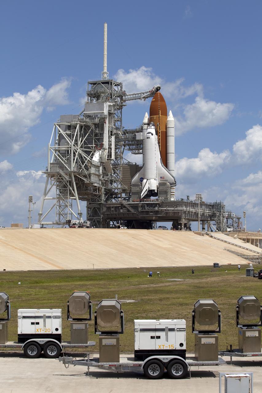 CAPE CANAVERAL, Fla. -- At Launch Pad 39A at NASA's Kennedy Space Center in Florida, the rotating service structure (RSS) is moved away from space shuttle Endeavour in preparation for the shuttle's upcoming launch. Retraction of the structure, which provides weather protection and access to the shuttle, began at 11:44 a.m. EDT and was completed at 12:24 p.m.             RSS "rollback" is a significant milestone in Endeavour's STS-134 mission countdown. Liftoff is scheduled for May 16 at 8:56 a.m. EDT. Endeavour and its crew will deliver the Express Logistics Carrier-3, Alpha Magnetic Spectrometer-2 (AMS), a high-pressure gas tank and additional spare parts for the Dextre robotic helper to the station. This will be the final spaceflight for Endeavour. For more information visit, www.nasa.gov/mission_pages/shuttle/shuttlemissions/sts134/index.html. Photo credit: NASA/Frankie Martin
