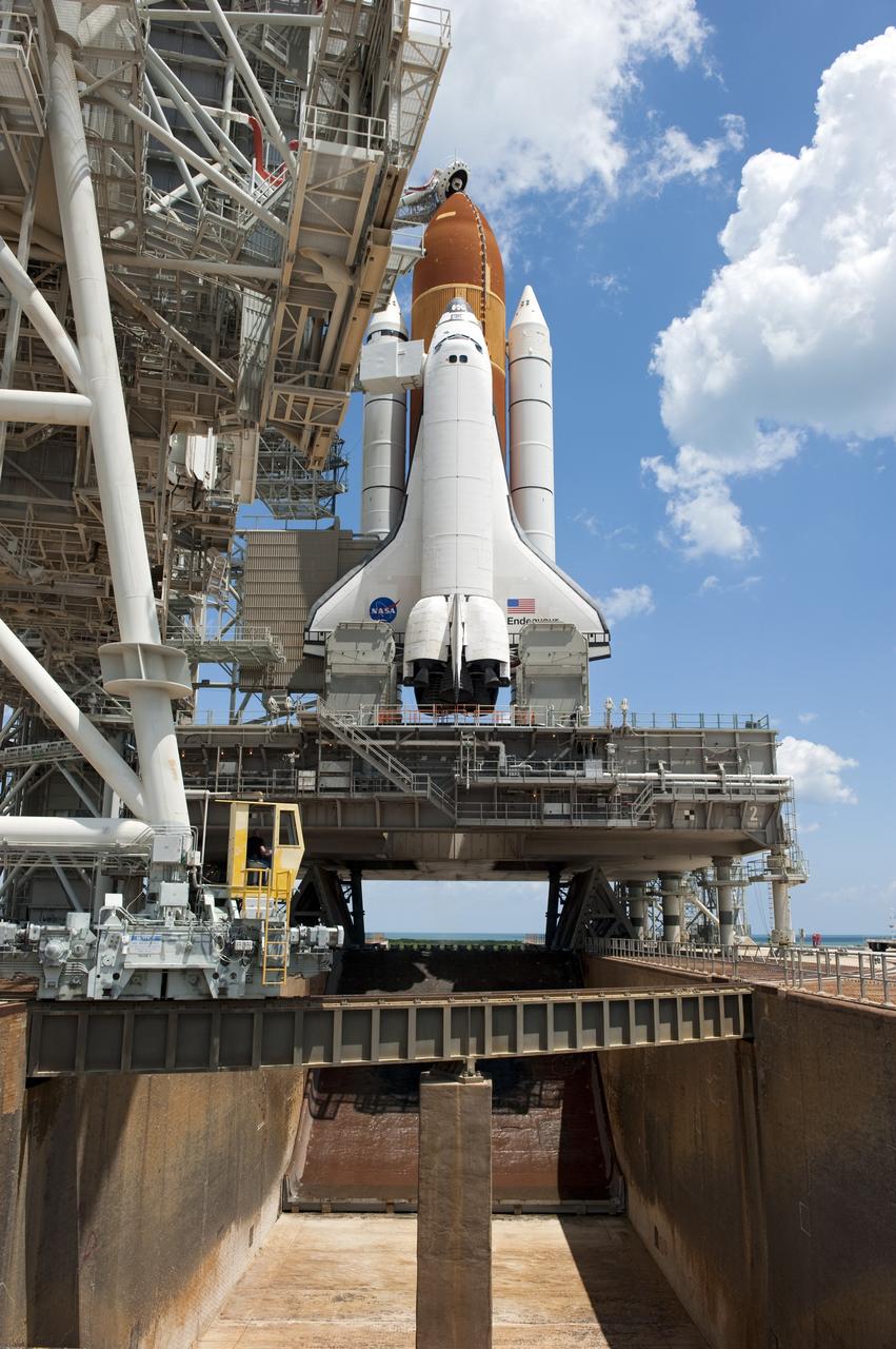 CAPE CANAVERAL, Fla. - At NASA's Kennedy Space Center in Florida, the rotating service structure (RSS) moves away from space shuttle Endeavour on Launch Pad 39A. The structure provides weather protection and access to the shuttle while it awaits lift off on the pad. RSS "rollback," as it's called, began at 11:44 a.m. EDT on May 15 and was completed at 12:24 p.m.             STS-134 will deliver the Alpha Magnetic Spectrometer-2 (AMS), Express Logistics Carrier-3, a high-pressure gas tank and additional spare parts for the Dextre robotic helper to the International Space Station. May 16 at 8:56 a.m. will be the second launch attempt for Endeavour. The first attempt on April 29 was scrubbed because of an issue associated with a faulty power distribution box called the aft load control assembly-2 (ALCA-2). STS-134 will be the final spaceflight for Endeavour. For more information visit, www.nasa.gov/mission_pages/shuttle/shuttlemissions/sts134/index.html. Photo credit: NASA/Kim Shiflett