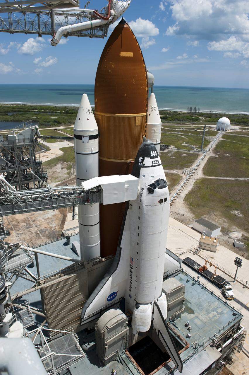 CAPE CANAVERAL, Fla. - Backdropped by a beautiful blue sky and the crystal-clear Atlantic Ocean, space shuttle Endeavour is revealed on Launch Pad 39A at NASA's Kennedy Space Center in Florida following the move of the rotating service structure (RSS). The structure provides weather protection and access to the shuttle while it awaits lift off on the pad. RSS "rollback," as it's called, began at 11:44 a.m. EDT on May 15 and was completed at 12:24 p.m.         STS-134 will deliver the Alpha Magnetic Spectrometer-2 (AMS), Express Logistics Carrier-3, a high-pressure gas tank and additional spare parts for the Dextre robotic helper to the International Space Station. May 16 at 8:56 a.m. will be the second launch attempt for Endeavour. The first attempt on April 29 was scrubbed because of an issue associated with a faulty power distribution box called the aft load control assembly-2 (ALCA-2). STS-134 will be the final spaceflight for Endeavour. For more information visit, www.nasa.gov/mission_pages/shuttle/shuttlemissions/sts134/index.html. Photo credit: NASA/Kim Shiflett