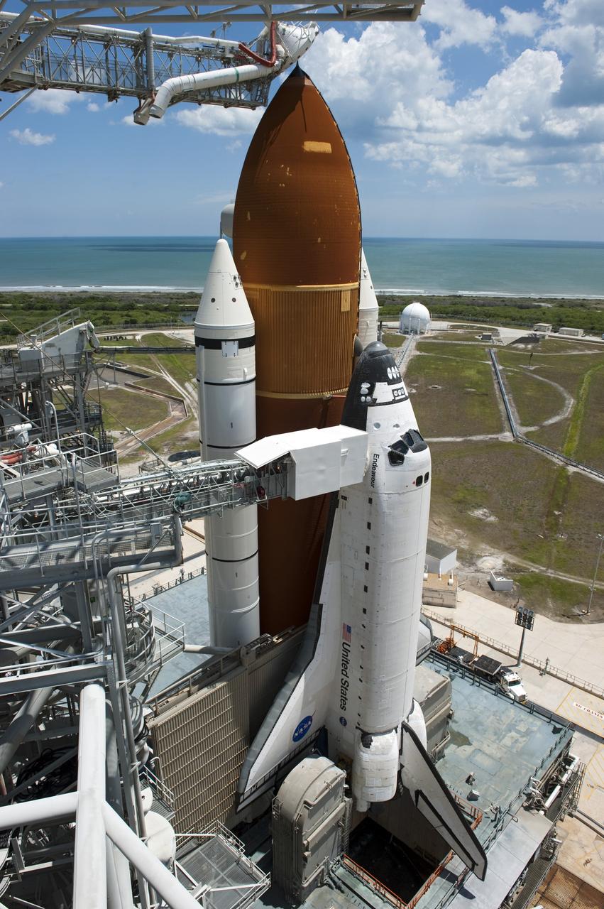 CAPE CANAVERAL, Fla. - Backdropped by a beautiful blue sky and the crystal-clear Atlantic Ocean, space shuttle Endeavour is revealed on Launch Pad 39A at NASA's Kennedy Space Center in Florida following the move of the rotating service structure (RSS). The structure provides weather protection and access to the shuttle while it awaits lift off on the pad. RSS "rollback," as it's called, began at 11:44 a.m. EDT on May 15 and was completed at 12:24 p.m.       STS-134 will deliver the Alpha Magnetic Spectrometer-2 (AMS), Express Logistics Carrier-3, a high-pressure gas tank and additional spare parts for the Dextre robotic helper to the International Space Station. May 16 at 8:56 a.m. will be the second launch attempt for Endeavour. The first attempt on April 29 was scrubbed because of an issue associated with a faulty power distribution box called the aft load control assembly-2 (ALCA-2). STS-134 will be the final spaceflight for Endeavour. For more information visit, www.nasa.gov/mission_pages/shuttle/shuttlemissions/sts134/index.html. Photo credit: NASA/Kim Shiflett