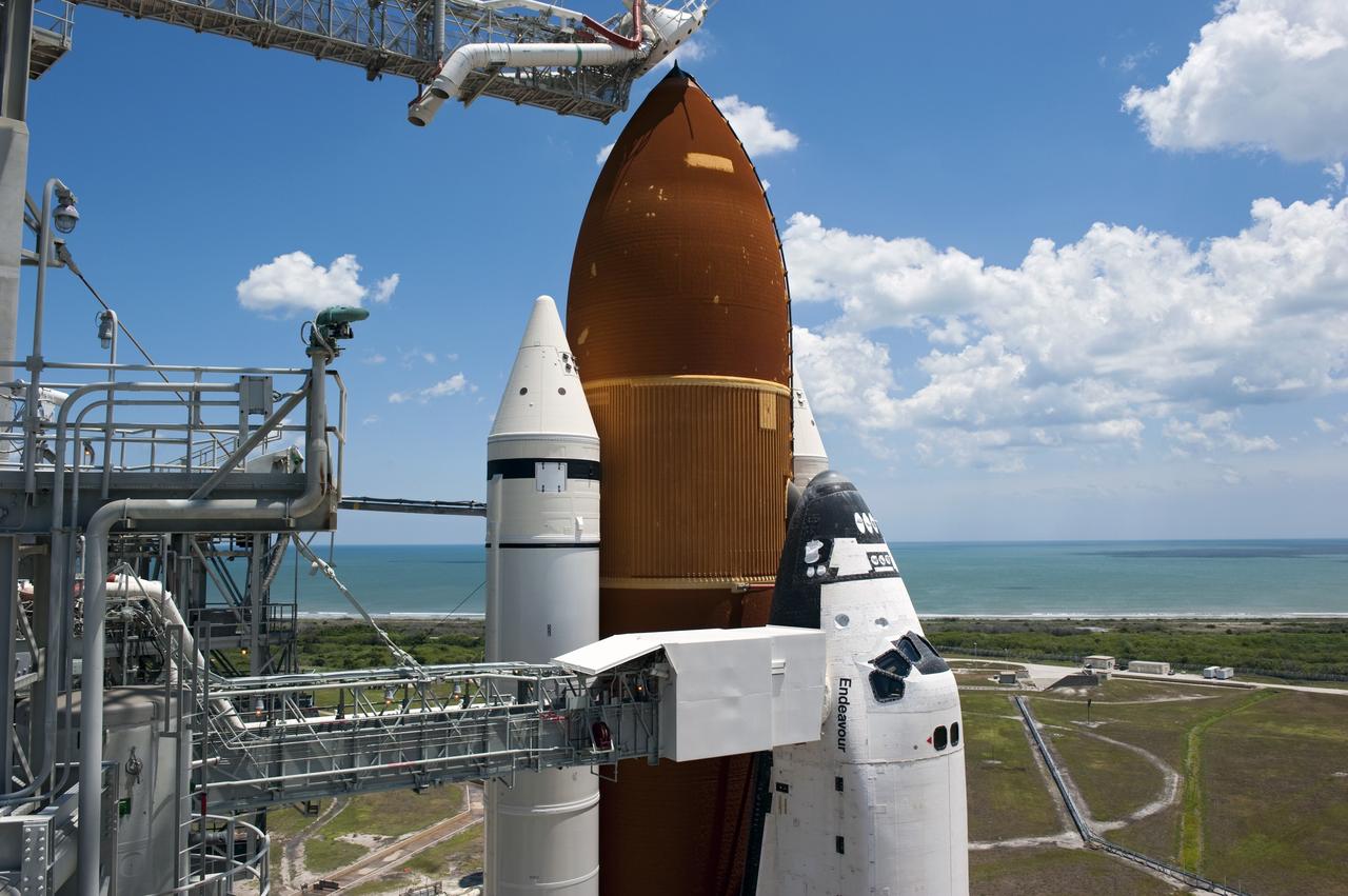 CAPE CANAVERAL, Fla. - Backdropped by a beautiful blue sky and the crystal-clear Atlantic Ocean, space shuttle Endeavour is revealed on Launch Pad 39A at NASA's Kennedy Space Center in Florida following the move of the rotating service structure (RSS). The structure provides weather protection and access to the shuttle while it awaits lift off on the pad. RSS "rollback," as it's called, began at 11:44 a.m. EDT on May 15 and was completed at 12:24 p.m.     STS-134 will deliver the Alpha Magnetic Spectrometer-2 (AMS), Express Logistics Carrier-3, a high-pressure gas tank and additional spare parts for the Dextre robotic helper to the International Space Station. May 16 at 8:56 a.m. will be the second launch attempt for Endeavour. The first attempt on April 29 was scrubbed because of an issue associated with a faulty power distribution box called the aft load control assembly-2 (ALCA-2). STS-134 will be the final spaceflight for Endeavour. For more information visit, www.nasa.gov/mission_pages/shuttle/shuttlemissions/sts134/index.html. Photo credit: NASA/Kim Shiflett