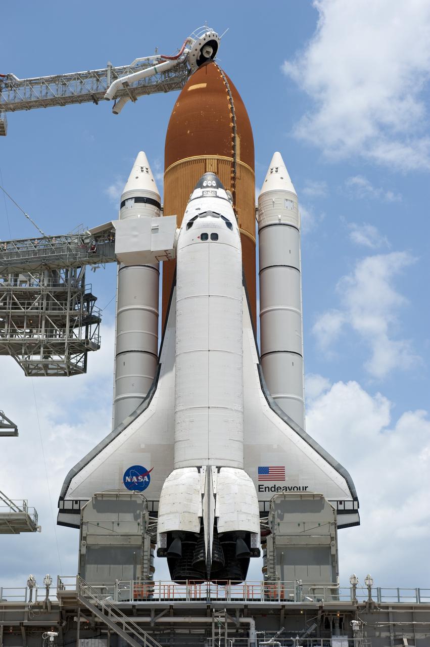 CAPE CANAVERAL, Fla. - At NASA's Kennedy Space Center in Florida, space shuttle Endeavour is revealed on Launch Pad 39A at NASA's Kennedy Space Center in Florida following the move of the rotating service structure (RSS). The structure provides weather protection and access to the shuttle while it awaits lift off on the pad. RSS "rollback," as it's called, began at 11:44 a.m. EDT on May 15 and was completed at 12:24 p.m.       STS-134 will deliver the Alpha Magnetic Spectrometer-2 (AMS), Express Logistics Carrier-3, a high-pressure gas tank and additional spare parts for the Dextre robotic helper to the International Space Station. May 16 at 8:56 a.m. will be the second launch attempt for Endeavour. The first attempt on April 29 was scrubbed because of an issue associated with a faulty power distribution box called the aft load control assembly-2 (ALCA-2). STS-134 will be the final spaceflight for Endeavour. For more information visit, www.nasa.gov/mission_pages/shuttle/shuttlemissions/sts134/index.html. Photo credit: NASA/Kim Shiflett