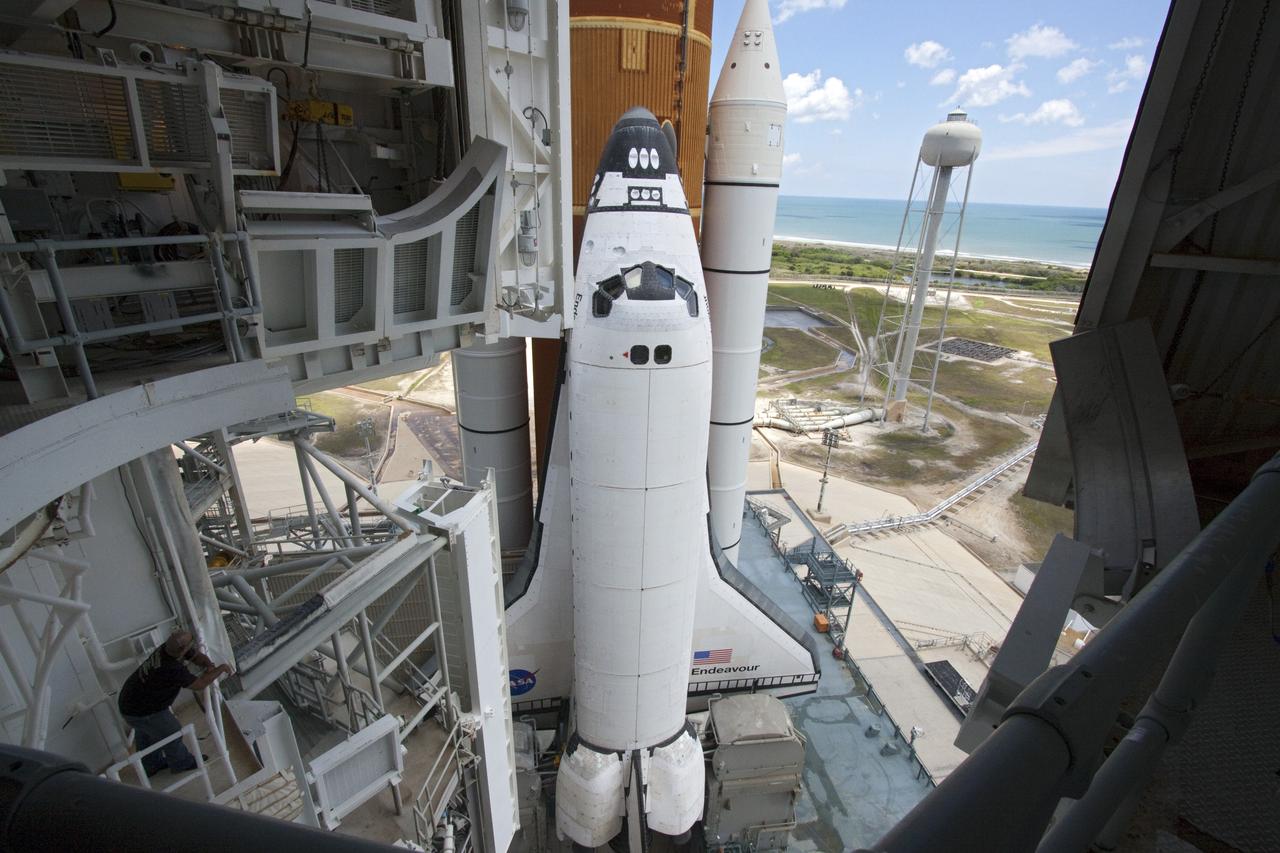 CAPE CANAVERAL, Fla. - Backdropped by a beautiful blue sky and the crystal-clear Atlantic Ocean, space shuttle Endeavour is revealed on Launch Pad 39A at NASA's Kennedy Space Center in Florida as the rotating service structure (RSS) moves away. The structure provides weather protection and access to the shuttle while it awaits lift off on the pad. RSS "rollback," as it's called, began at 11:44 a.m. EDT on May 15 and was completed at 12:24 p.m.       STS-134 will deliver the Alpha Magnetic Spectrometer-2 (AMS), Express Logistics Carrier-3, a high-pressure gas tank and additional spare parts for the Dextre robotic helper to the International Space Station. May 16 at 8:56 a.m. will be the second launch attempt for Endeavour. The first attempt on April 29 was scrubbed because of an issue associated with a faulty power distribution box called the aft load control assembly-2 (ALCA-2). STS-134 will be the final spaceflight for Endeavour. For more information visit, www.nasa.gov/mission_pages/shuttle/shuttlemissions/sts134/index.html. Photo credit: NASA/Jack Pfaller