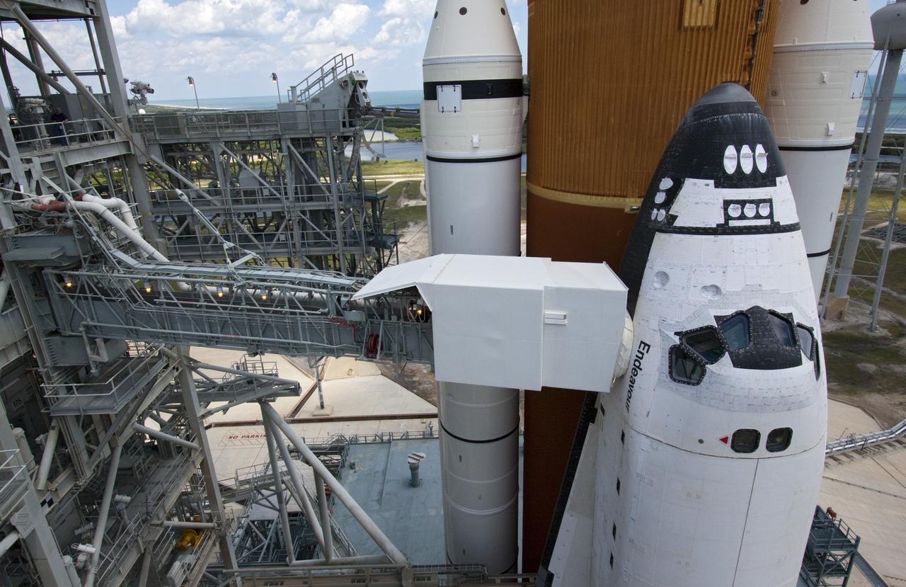CAPE CANAVERAL, Fla. - Backdropped by a beautiful blue sky and the crystal-clear Atlantic Ocean, space shuttle Endeavour is revealed on Launch Pad 39A at NASA's Kennedy Space Center in Florida as the rotating service structure (RSS) moves away. The structure provides weather protection and access to the shuttle while it awaits lift off on the pad. RSS "rollback," as it's called, began at 11:44 a.m. EDT on May 15 and was completed at 12:24 p.m.     STS-134 will deliver the Alpha Magnetic Spectrometer-2 (AMS), Express Logistics Carrier-3, a high-pressure gas tank and additional spare parts for the Dextre robotic helper to the International Space Station. May 16 at 8:56 a.m. will be the second launch attempt for Endeavour. The first attempt on April 29 was scrubbed because of an issue associated with a faulty power distribution box called the aft load control assembly-2 (ALCA-2). STS-134 will be the final spaceflight for Endeavour. For more information visit, www.nasa.gov/mission_pages/shuttle/shuttlemissions/sts134/index.html. Photo credit: NASA/Jack Pfaller