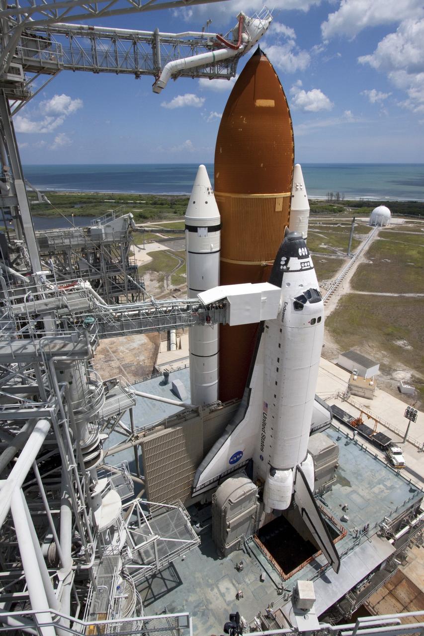 CAPE CANAVERAL, Fla. - Backdropped by a beautiful blue sky and the crystal-clear Atlantic Ocean, space shuttle Endeavour is revealed on Launch Pad 39A at NASA's Kennedy Space Center in Florida as the rotating service structure (RSS) moves away. The structure provides weather protection and access to the shuttle while it awaits lift off on the pad. RSS "rollback," as it's called, began at 11:44 a.m. EDT on May 15 and was completed at 12:24 p.m.         STS-134 will deliver the Alpha Magnetic Spectrometer-2 (AMS), Express Logistics Carrier-3, a high-pressure gas tank and additional spare parts for the Dextre robotic helper to the International Space Station. May 16 at 8:56 a.m. will be the second launch attempt for Endeavour. The first attempt on April 29 was scrubbed because of an issue associated with a faulty power distribution box called the aft load control assembly-2 (ALCA-2). STS-134 will be the final spaceflight for Endeavour. For more information visit, www.nasa.gov/mission_pages/shuttle/shuttlemissions/sts134/index.html. Photo credit: NASA/Jack Pfaller